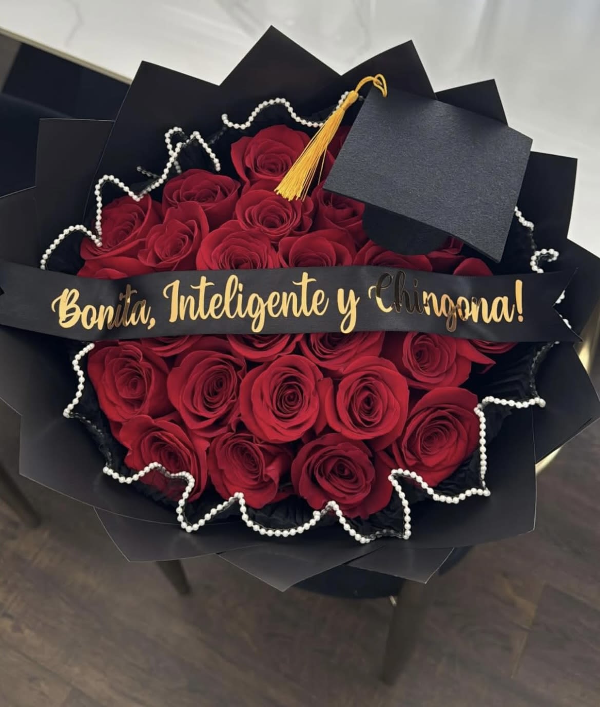 Bouquet of red roses with a graduation cap and gold tassel