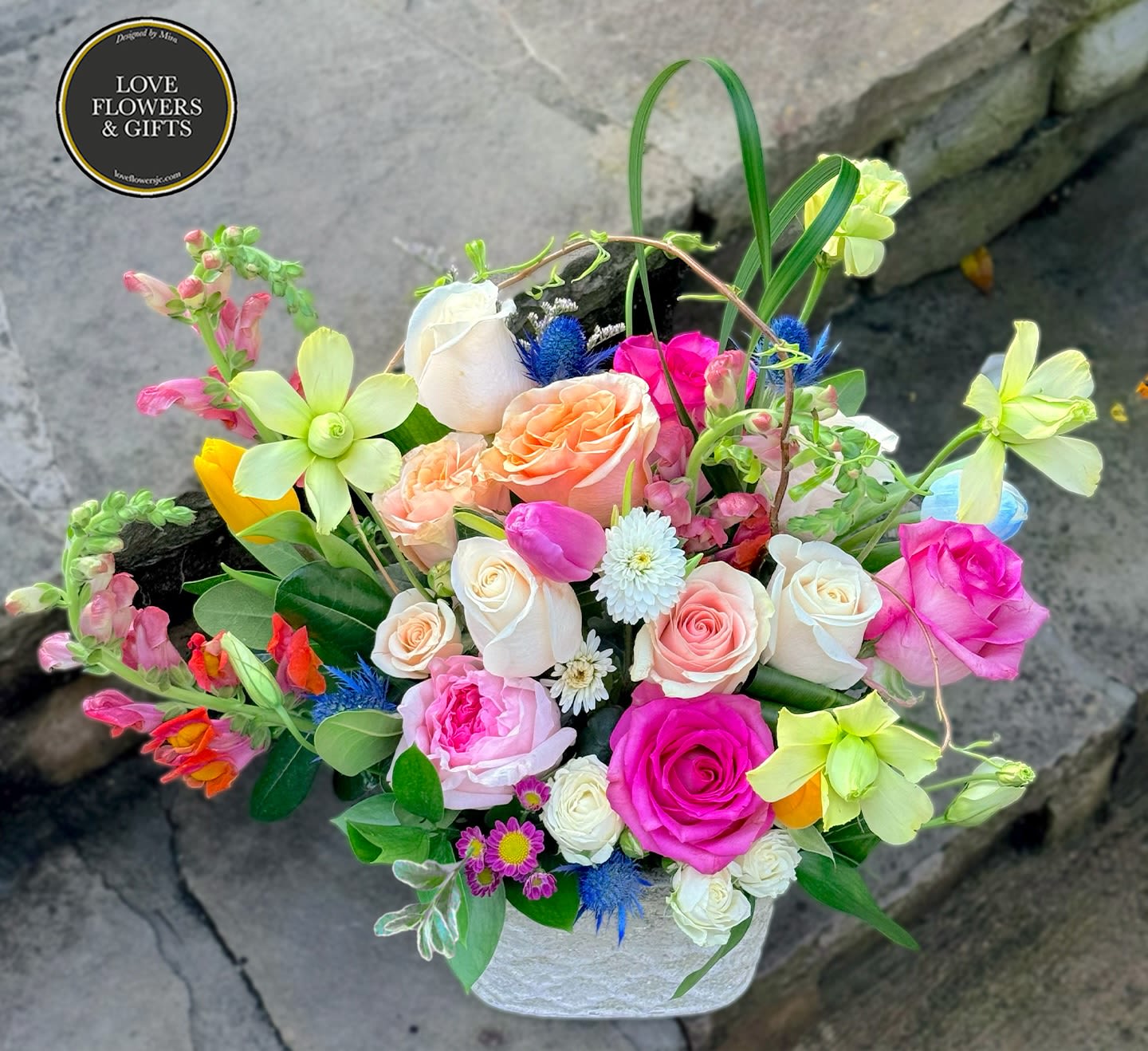 Jovial  - An abundant mix of spring textures and colors designed in a decorated ceramic vase that can reused as a pot. 