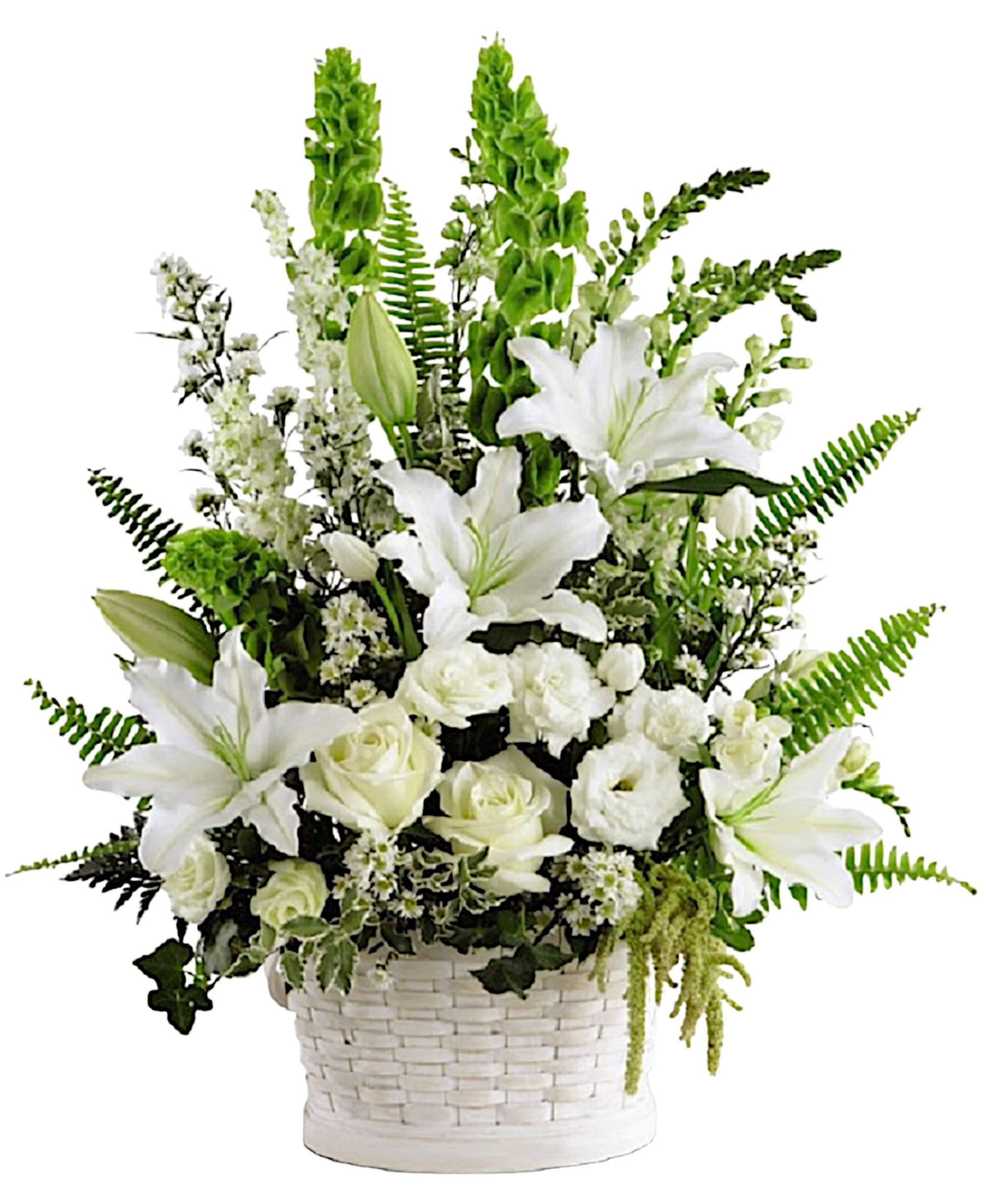 White lilies and roses arranged in a white basket with green accents