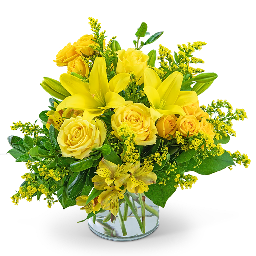 Yellow roses and lilies arranged in a clear glass vase
