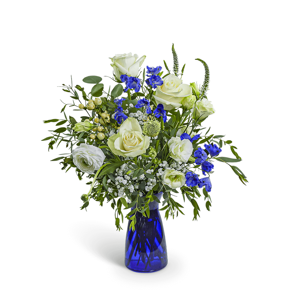 White roses and blue flowers in a cobalt glass vase