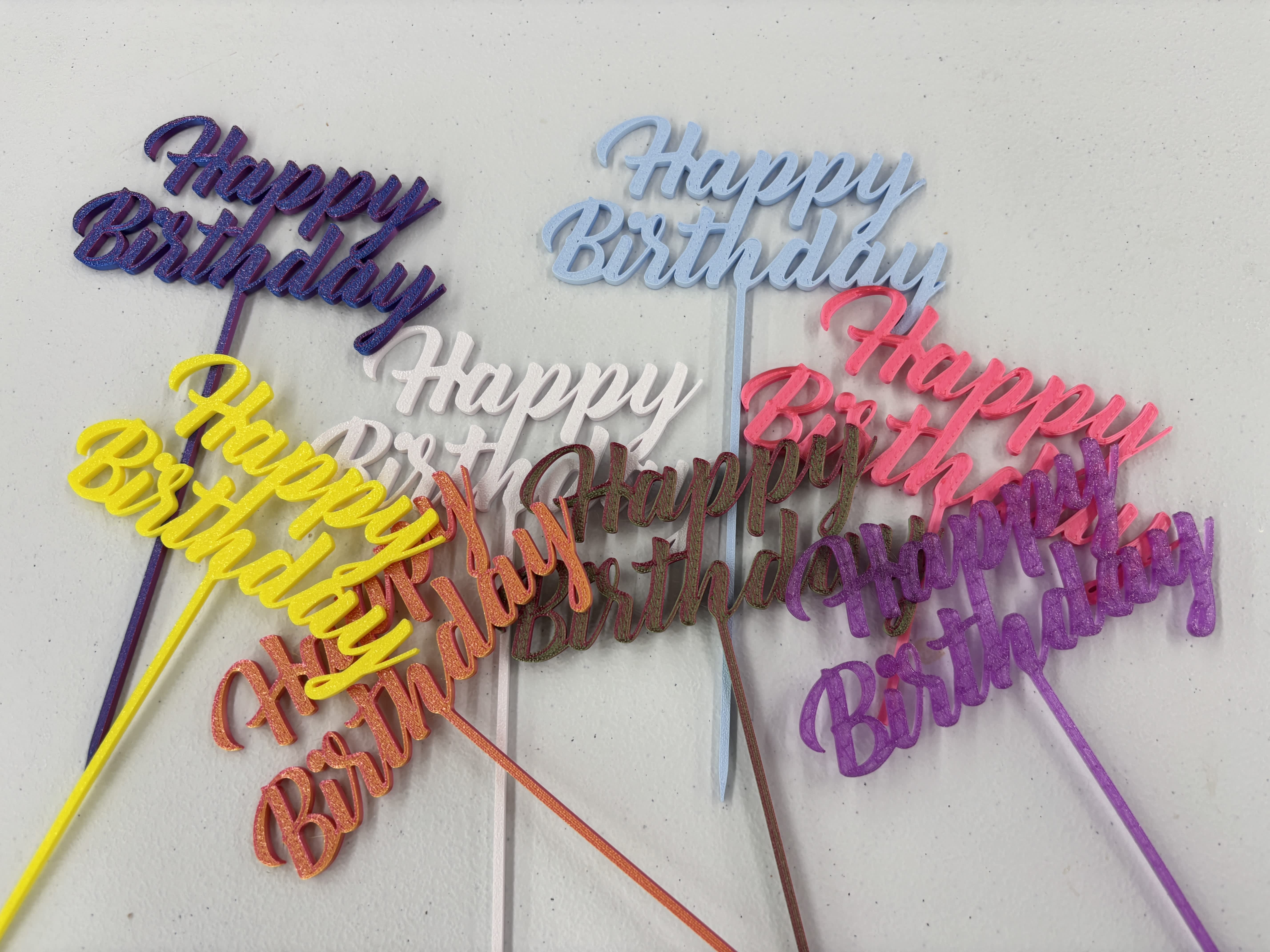 Colorful glitter birthday cake toppers with script text on sticks