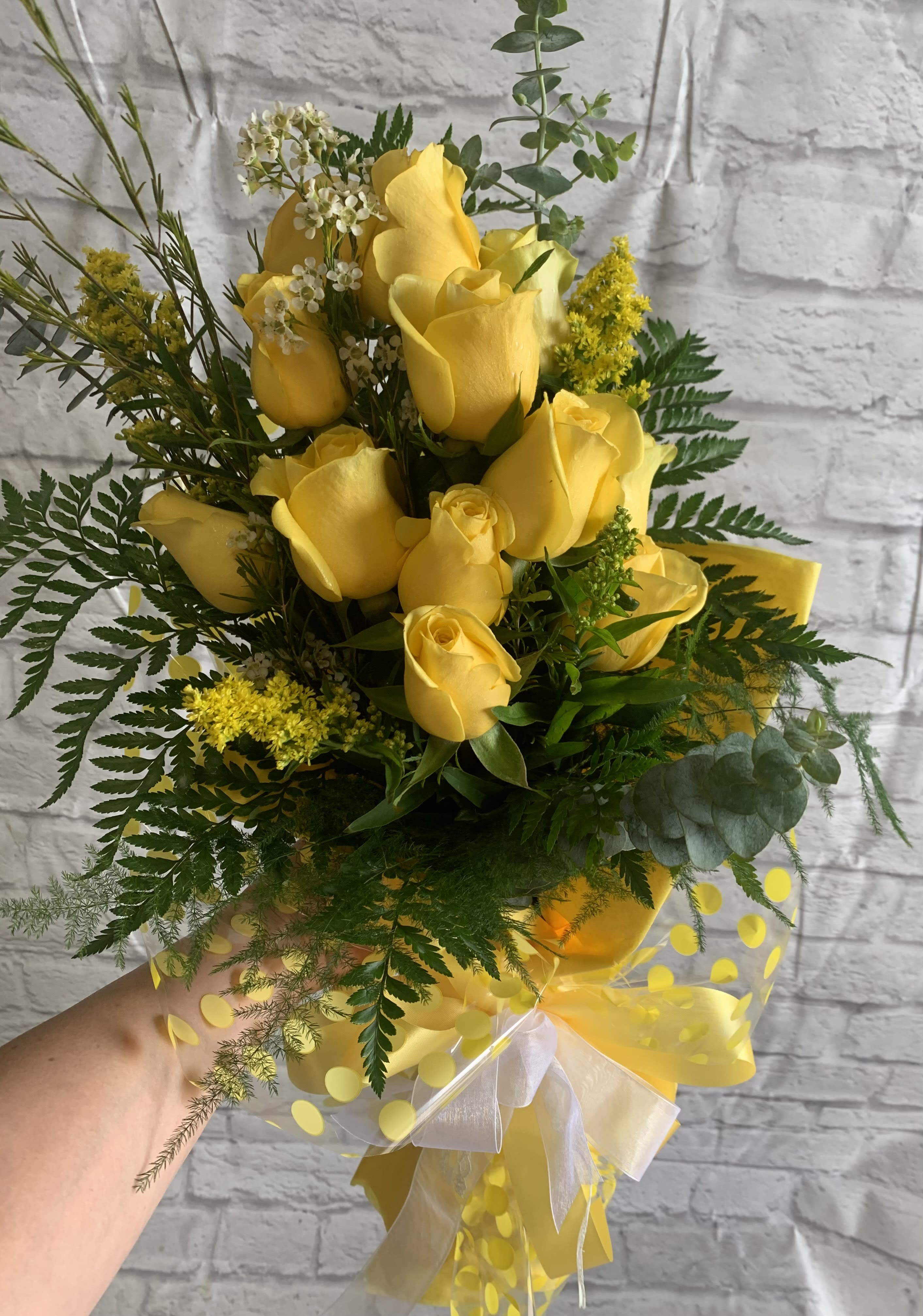 Yellow rose bouquet with greenery and a sheer ribbon wrap