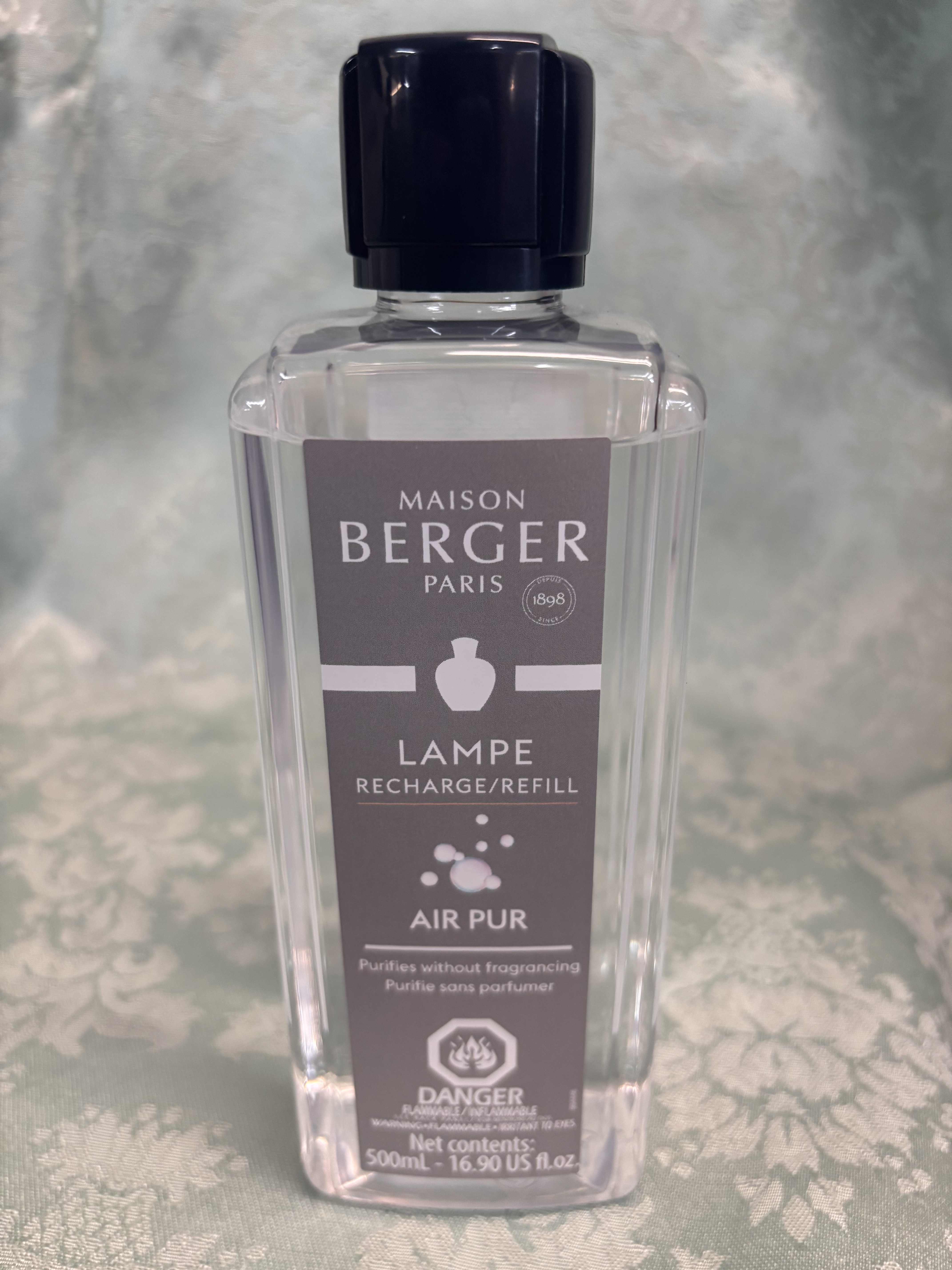 Clear bottle of Maison Berger Air Pur refill with a dark cap