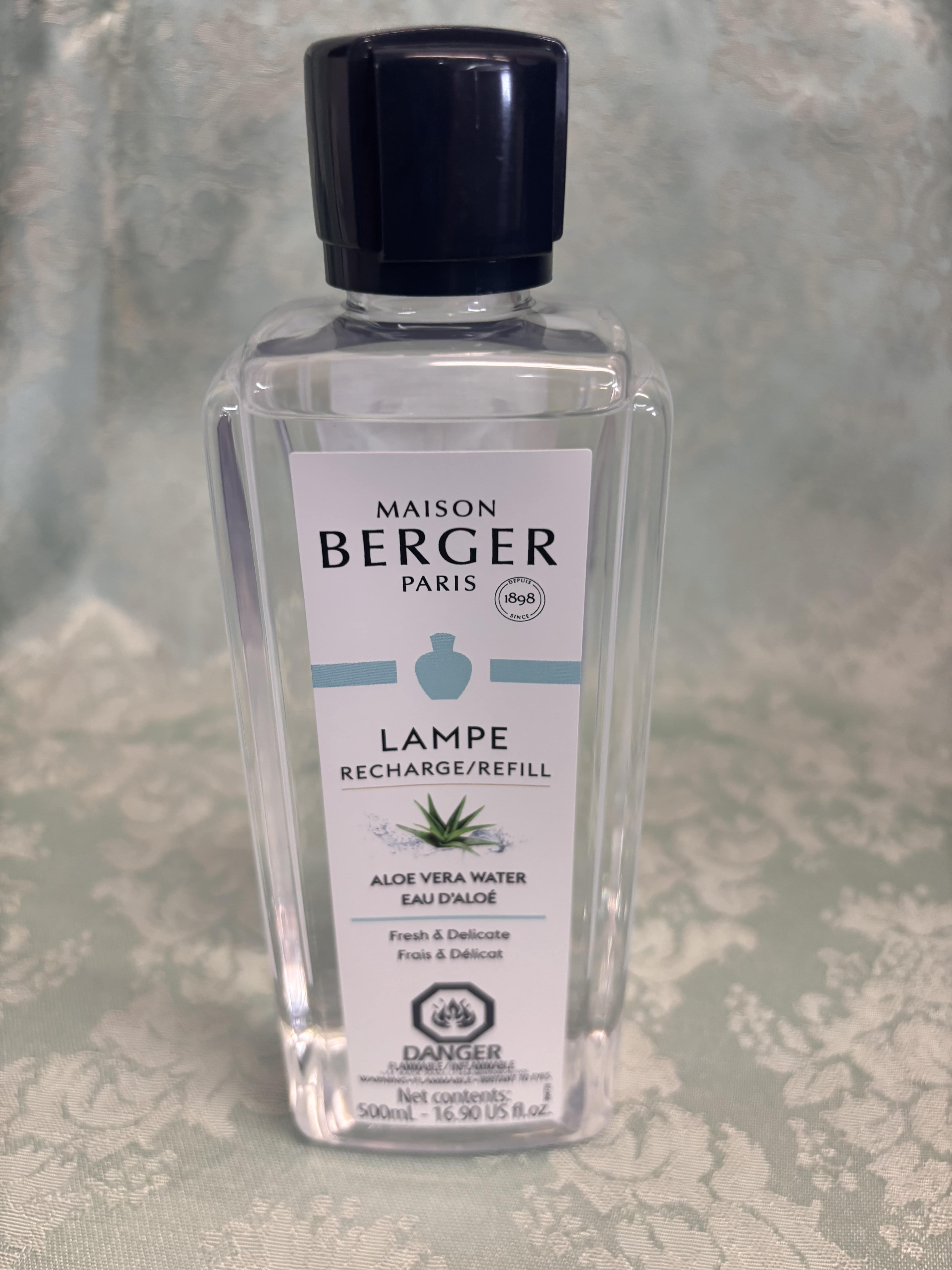 Clear bottle of Maison Berger Lampe refill with black cap