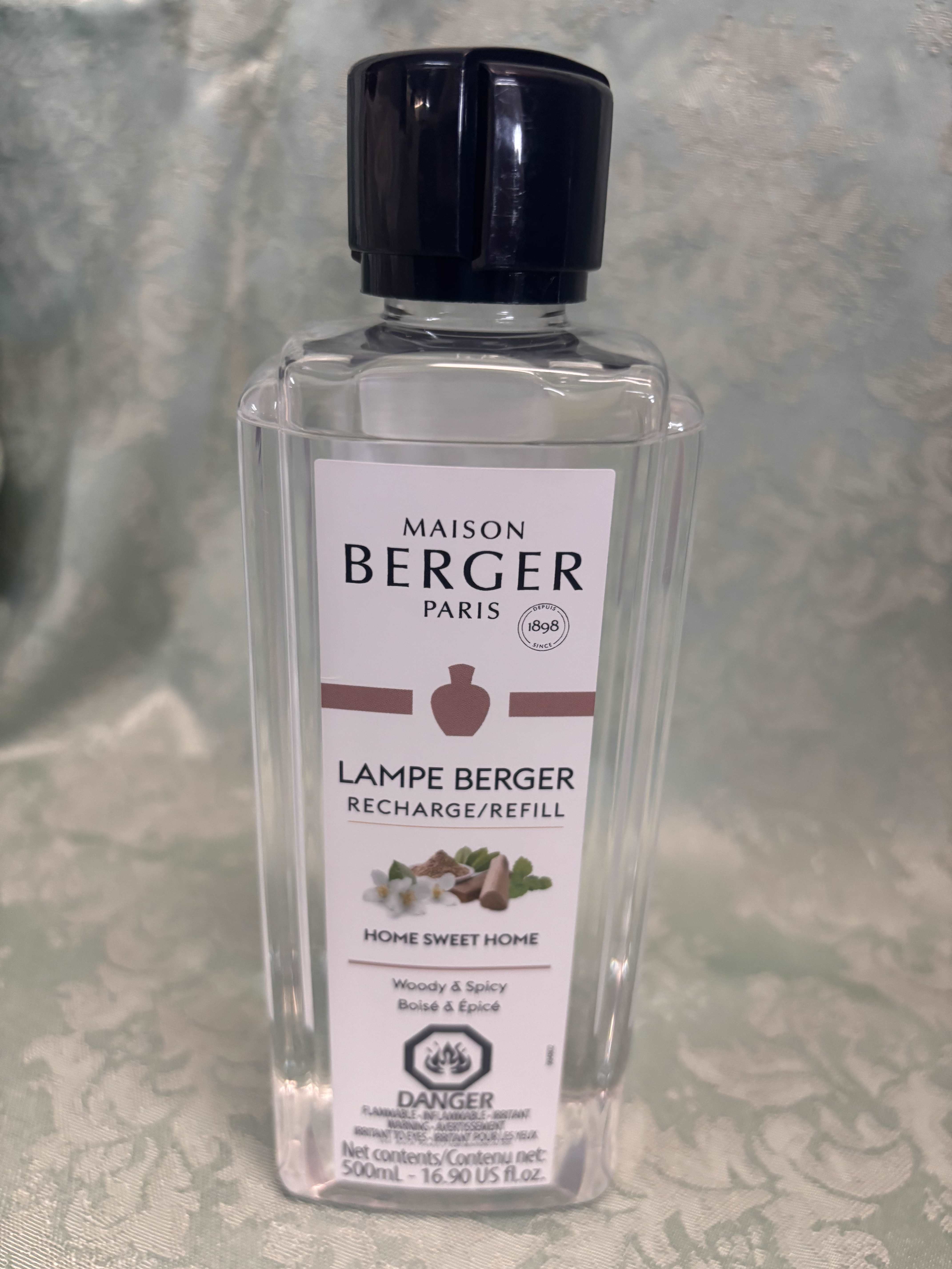 Clear bottle of Maison Berger Lampe Berger refill with a black cap