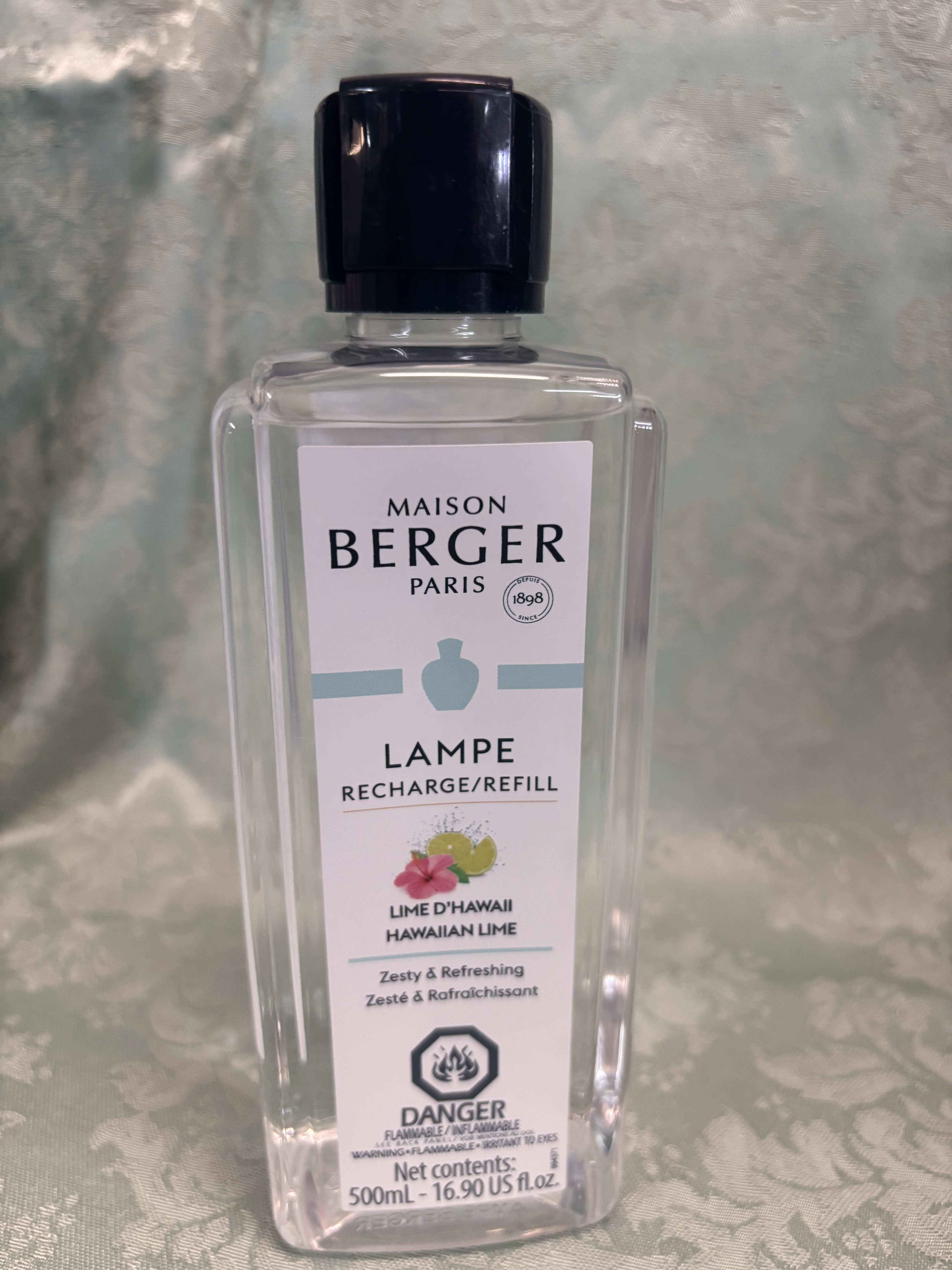 Clear bottle of Maison Berger Paris lamp refill with a black cap