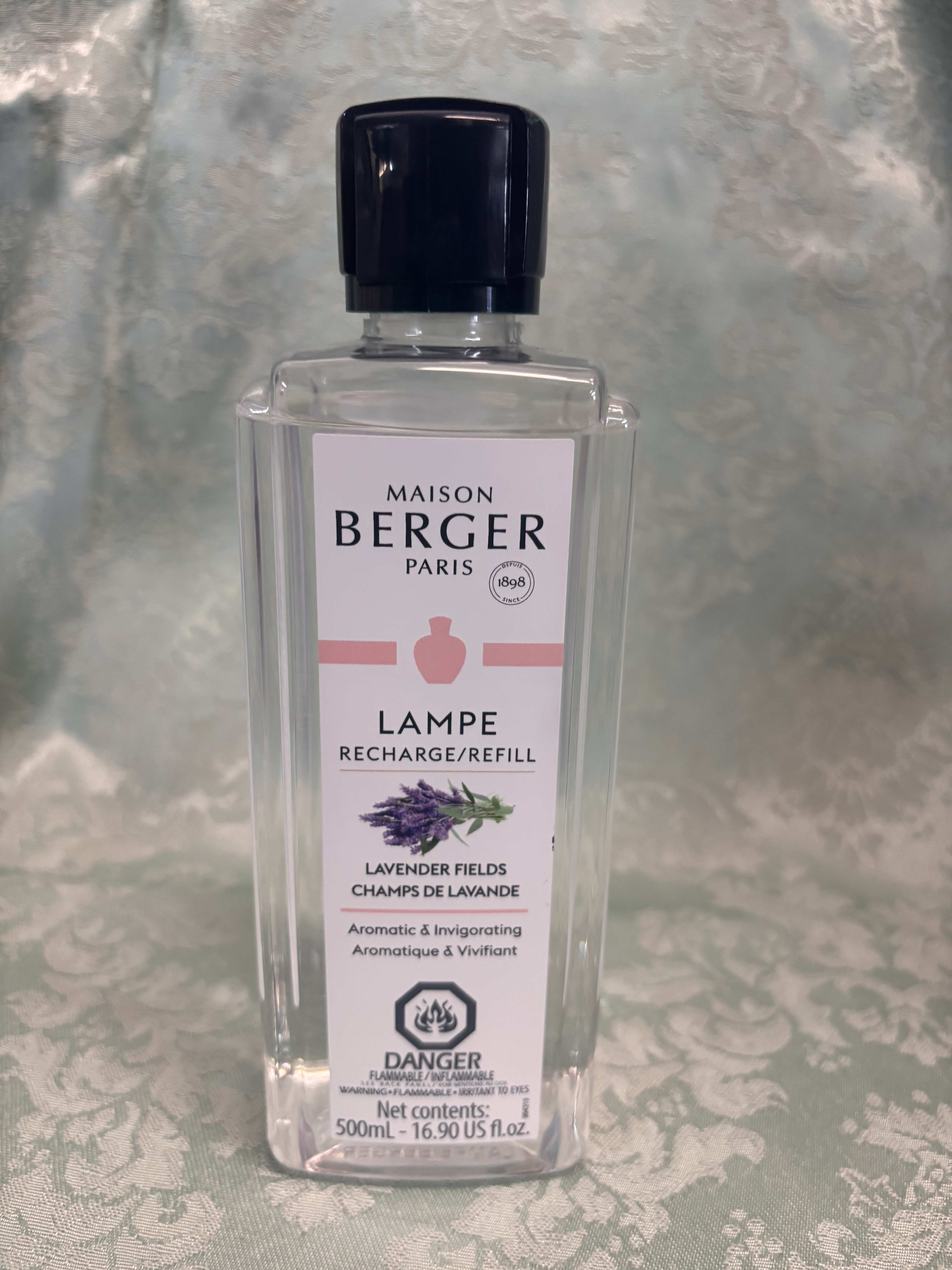 Clear bottle of Maison Berger lavender fields lamp refill with black cap