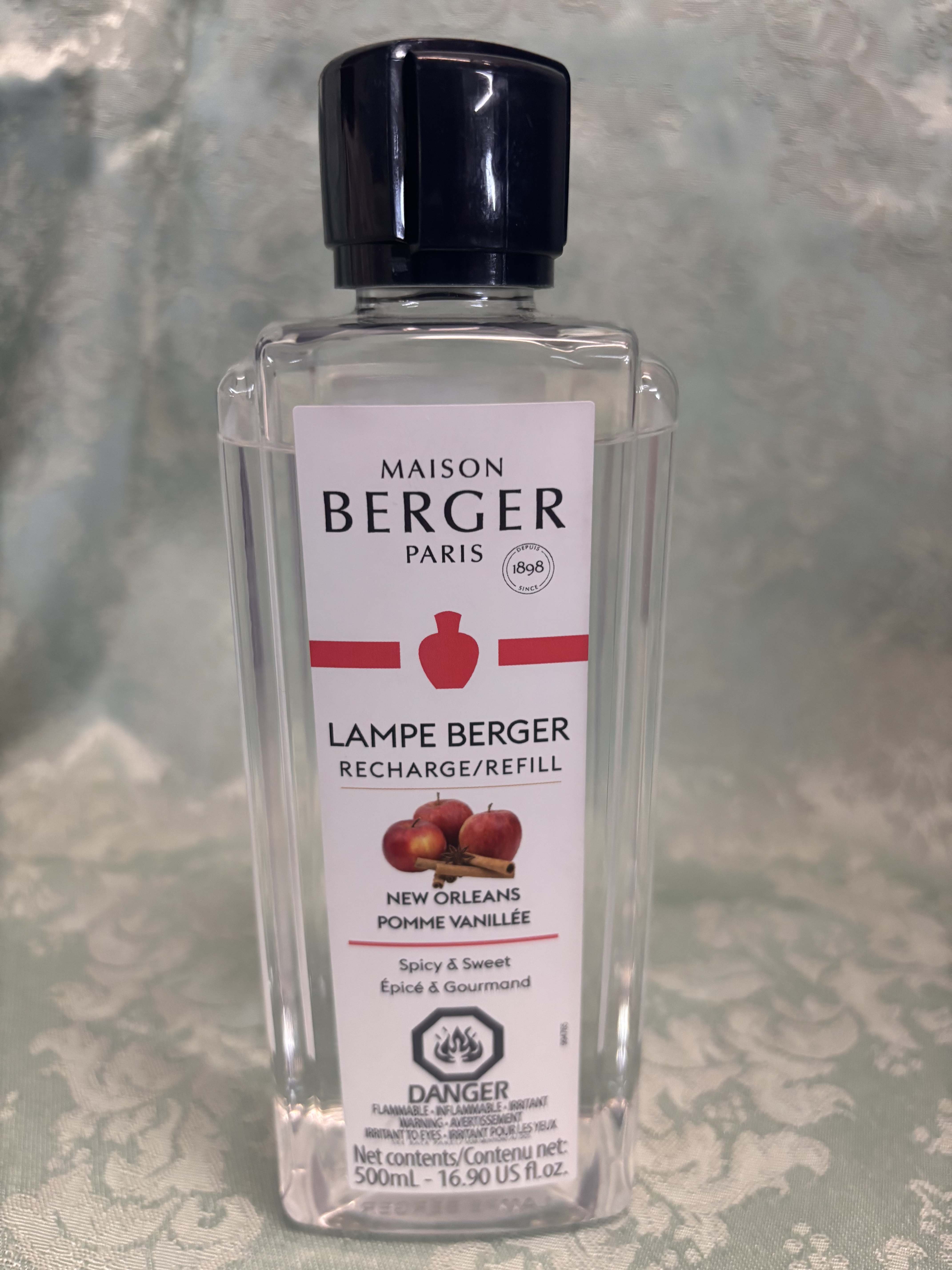 Clear bottle of Maison Berger Paris lamp refill with a black cap