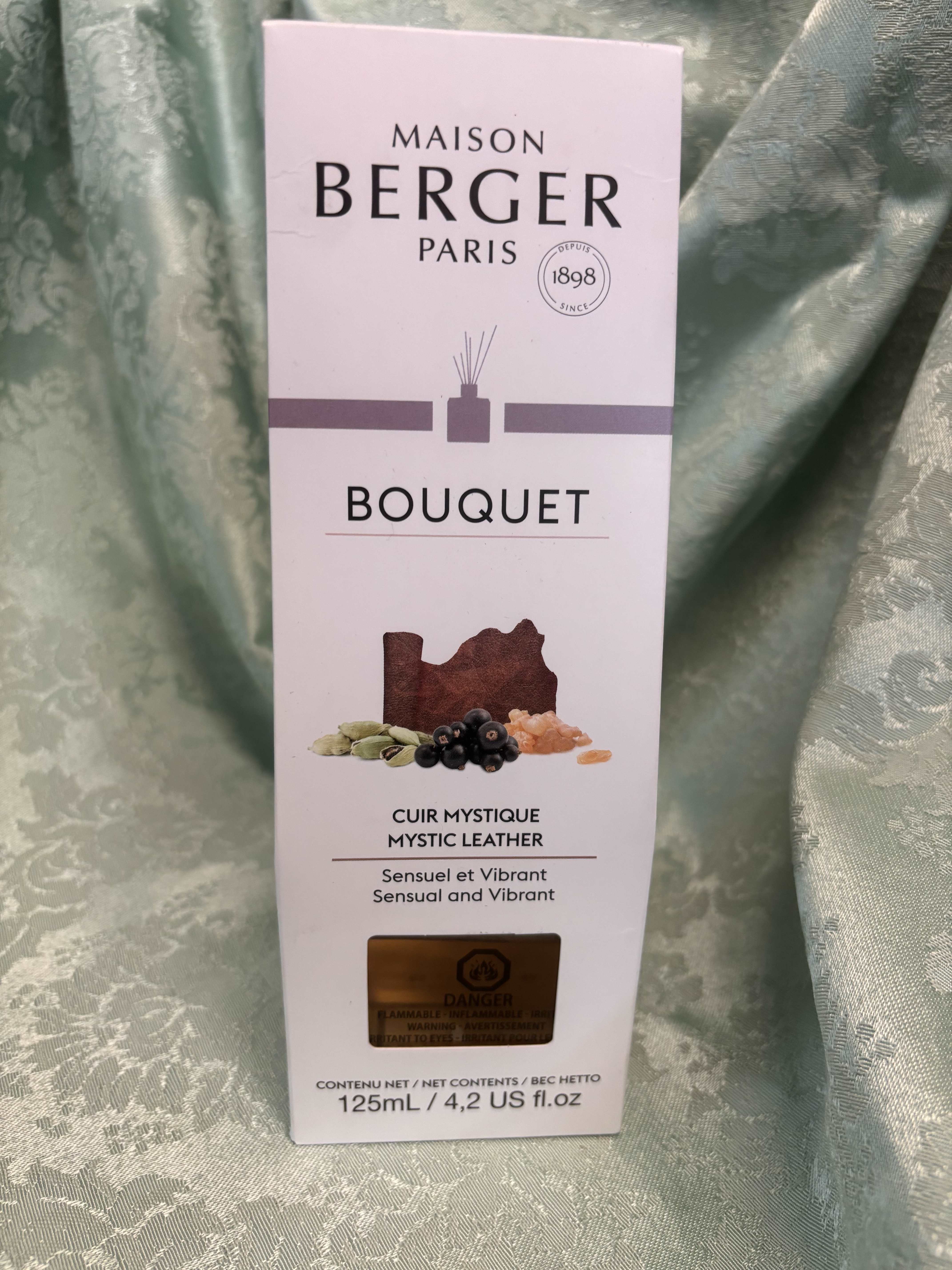 Maison Berger Paris Mystic Leather fragrance box on a green fabric background