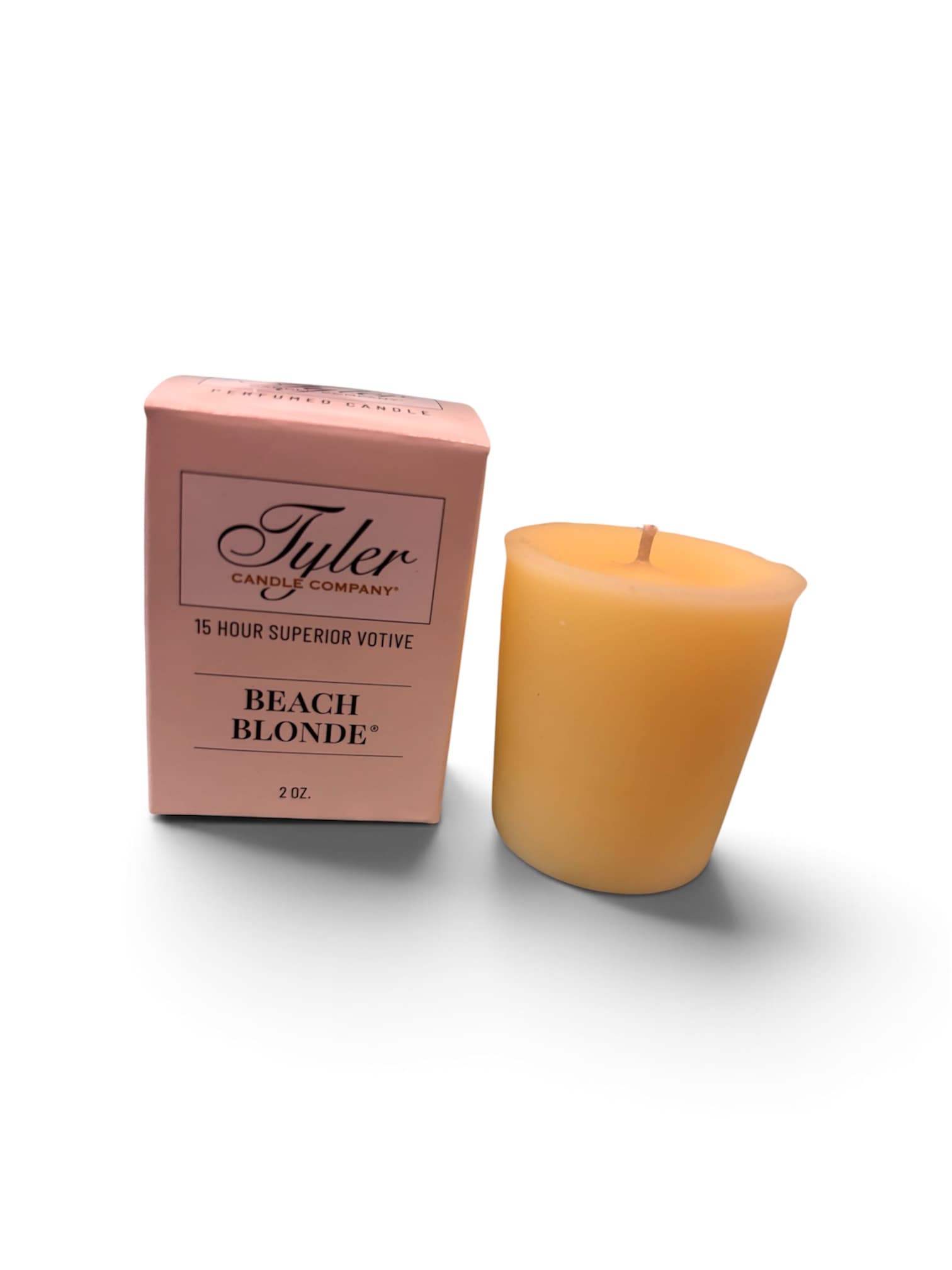 Pink boxed votive candle beside a yellow candle