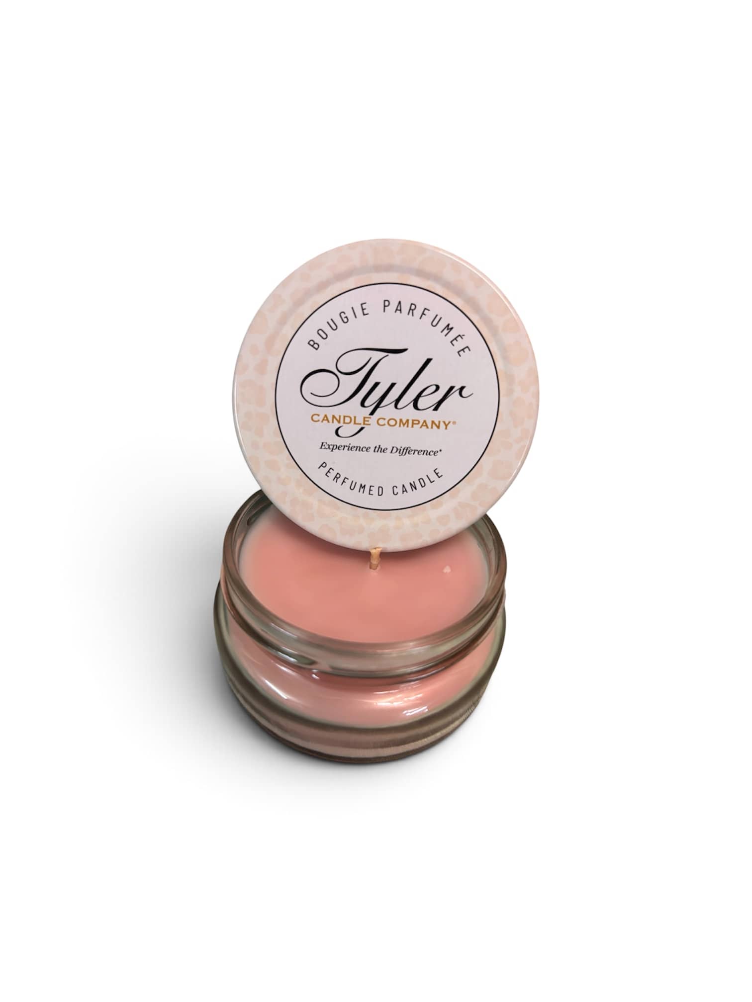 Pink scented candle in a glass jar with a round lid