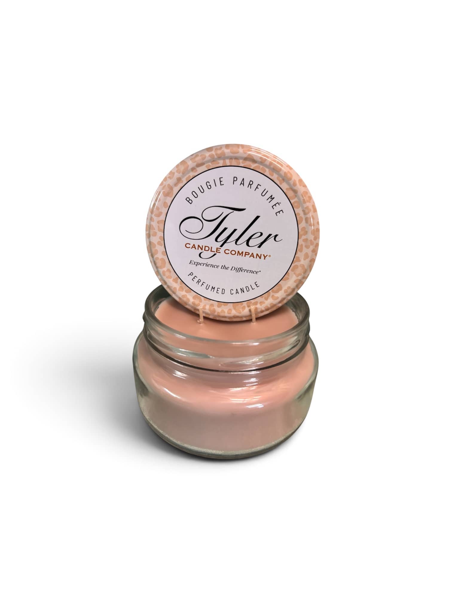 Pink scented candle in a glass jar with a labeled lid