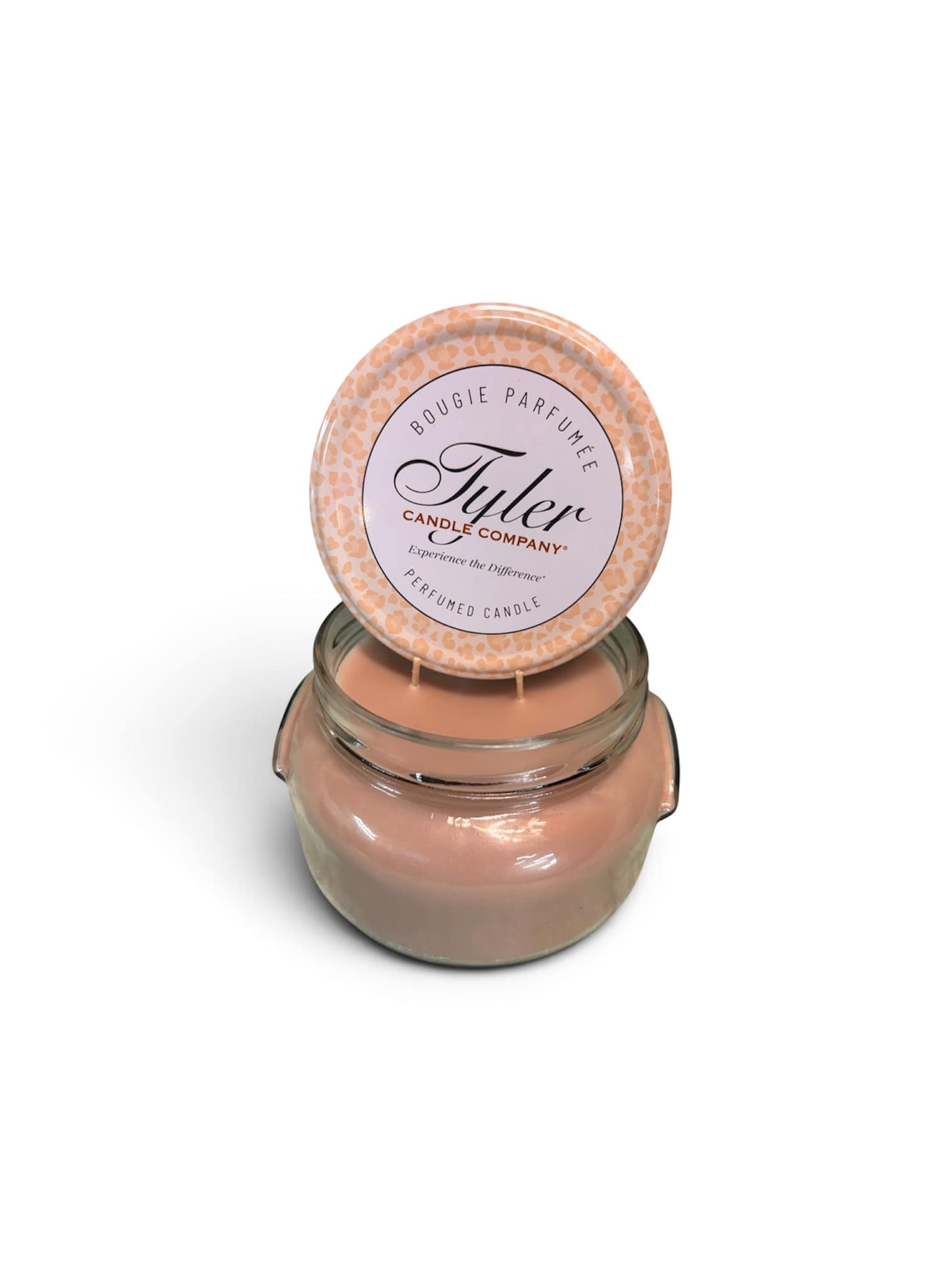 Peach scented candle in a glass jar with a round lid