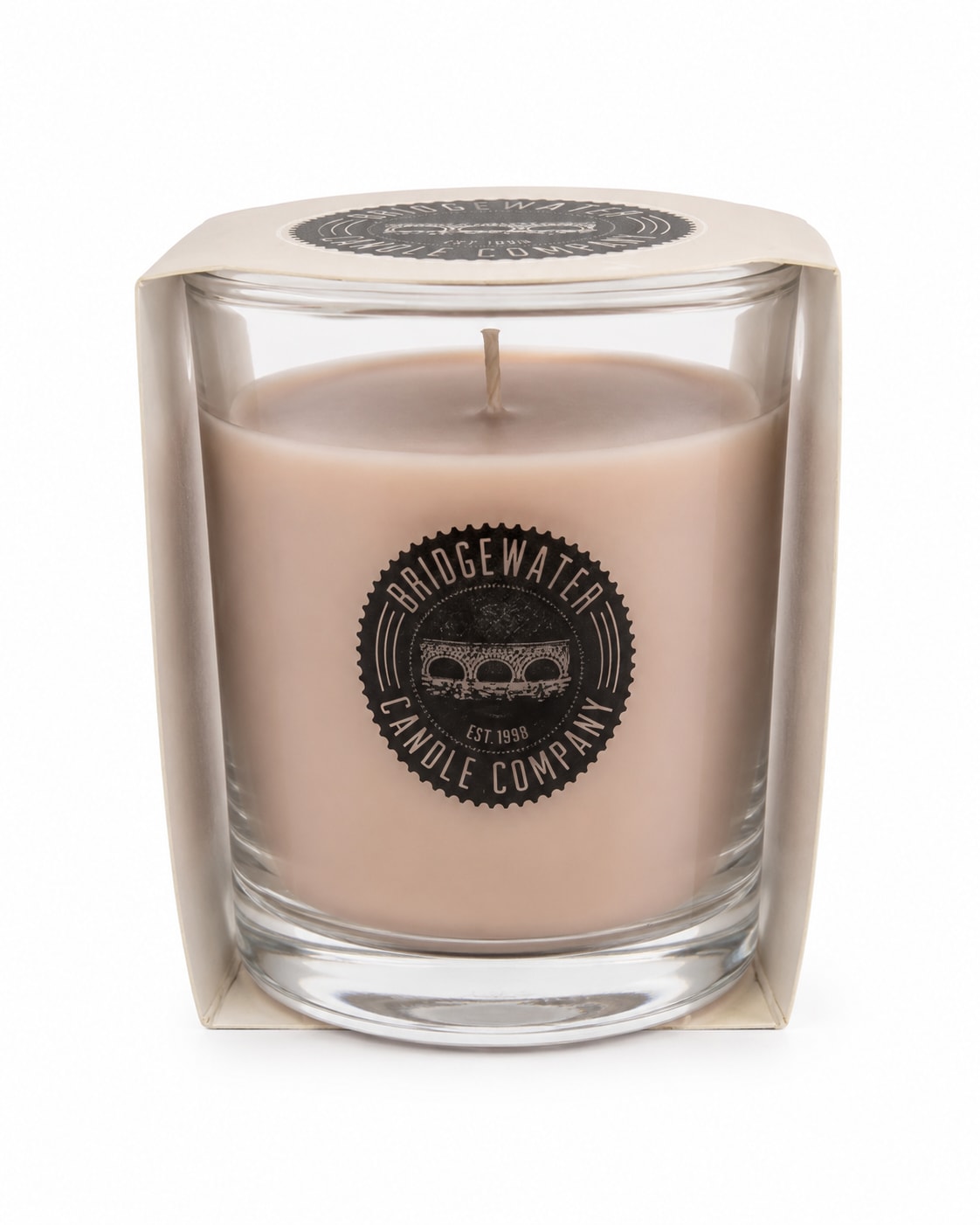 Beige candle in a clear glass container with boxed packaging