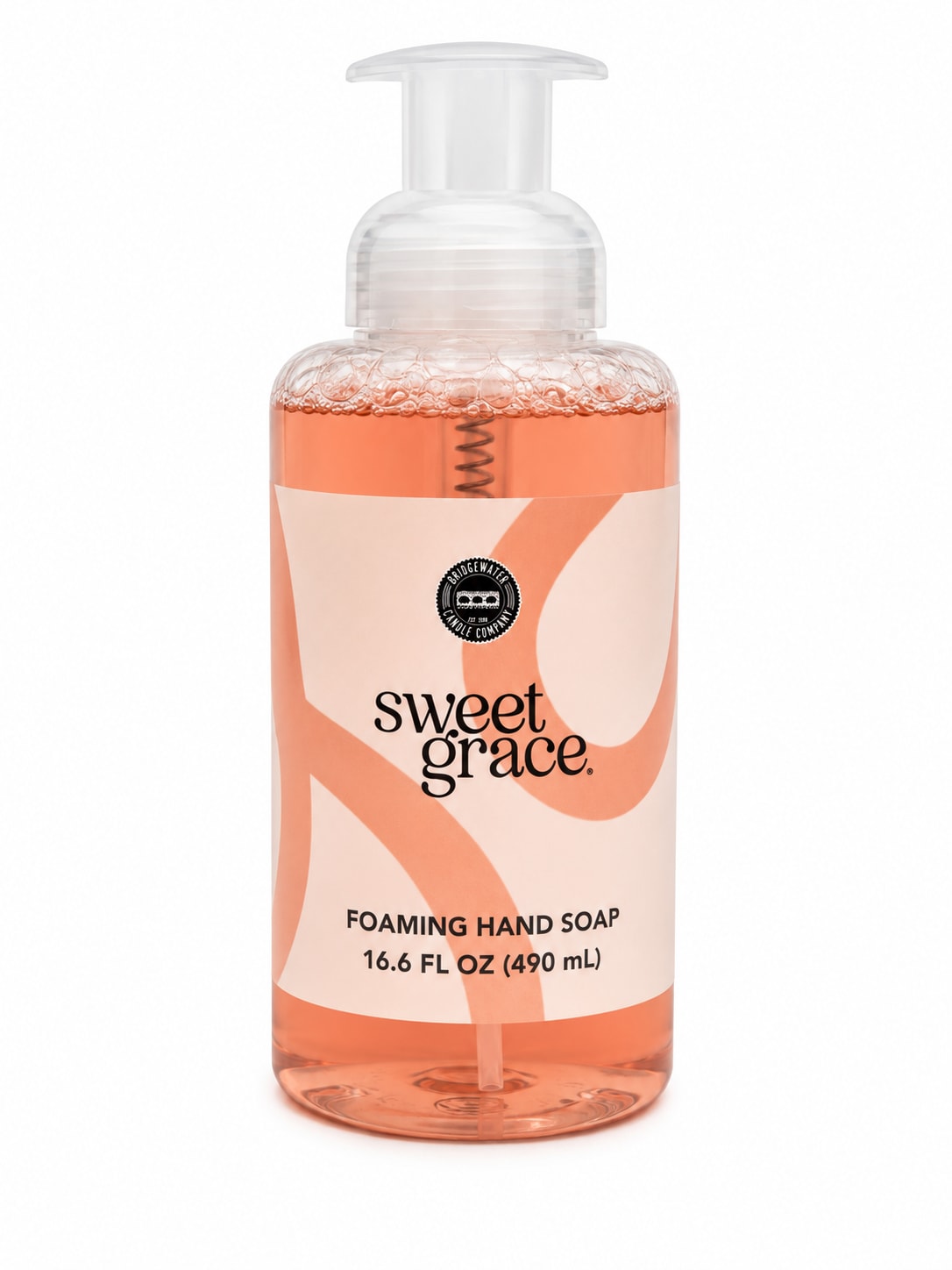 Bottle of foaming hand soap with a clear pump and peach-colored liquid