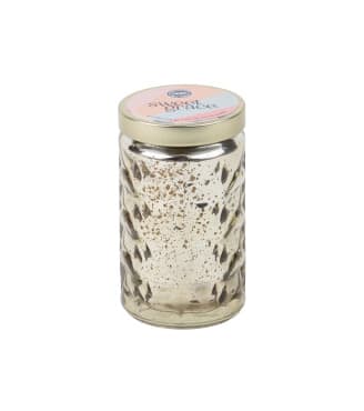 Decorative candle in a glass jar with a metal lid