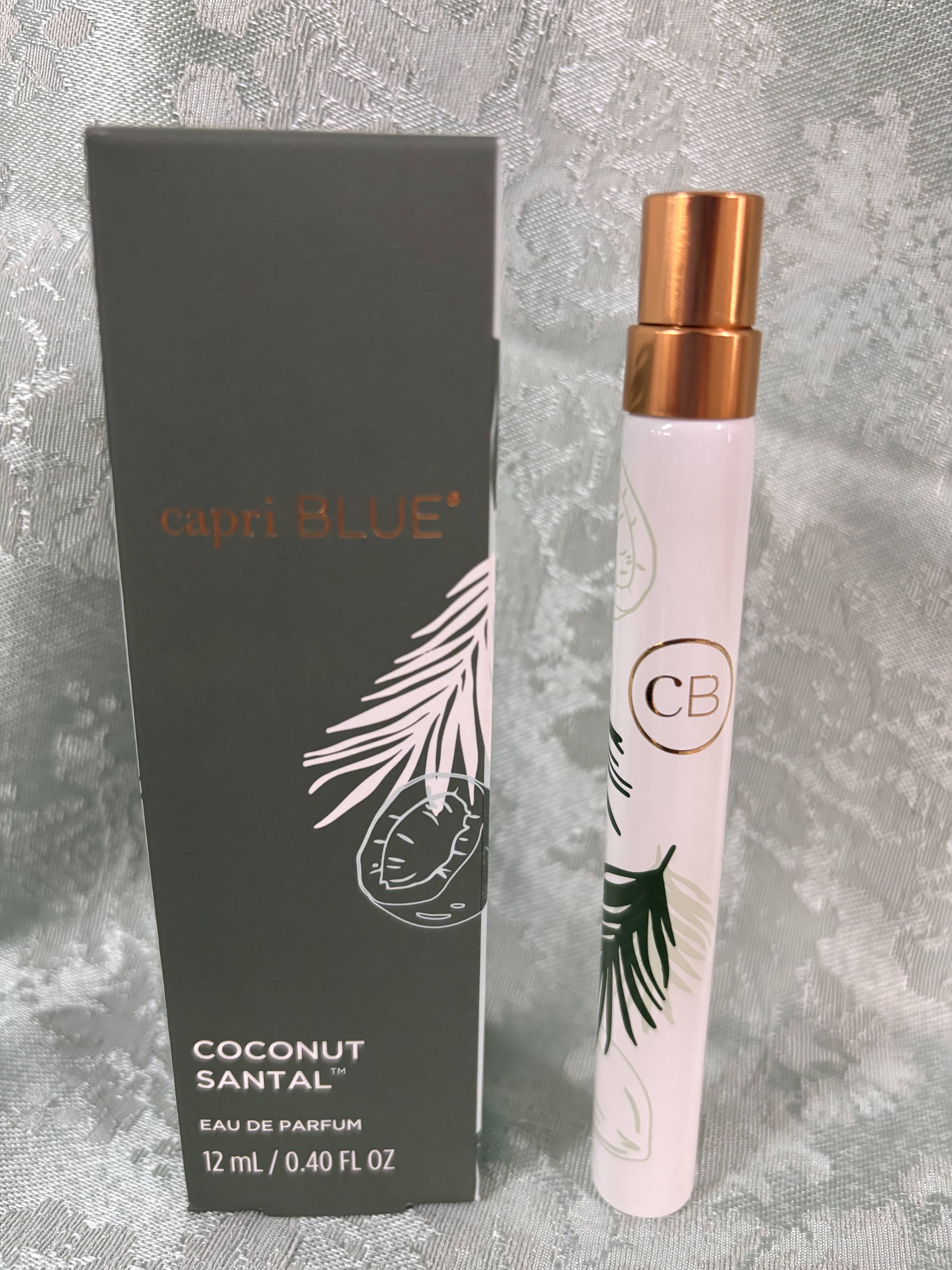 A small perfume spray bottle beside its box.