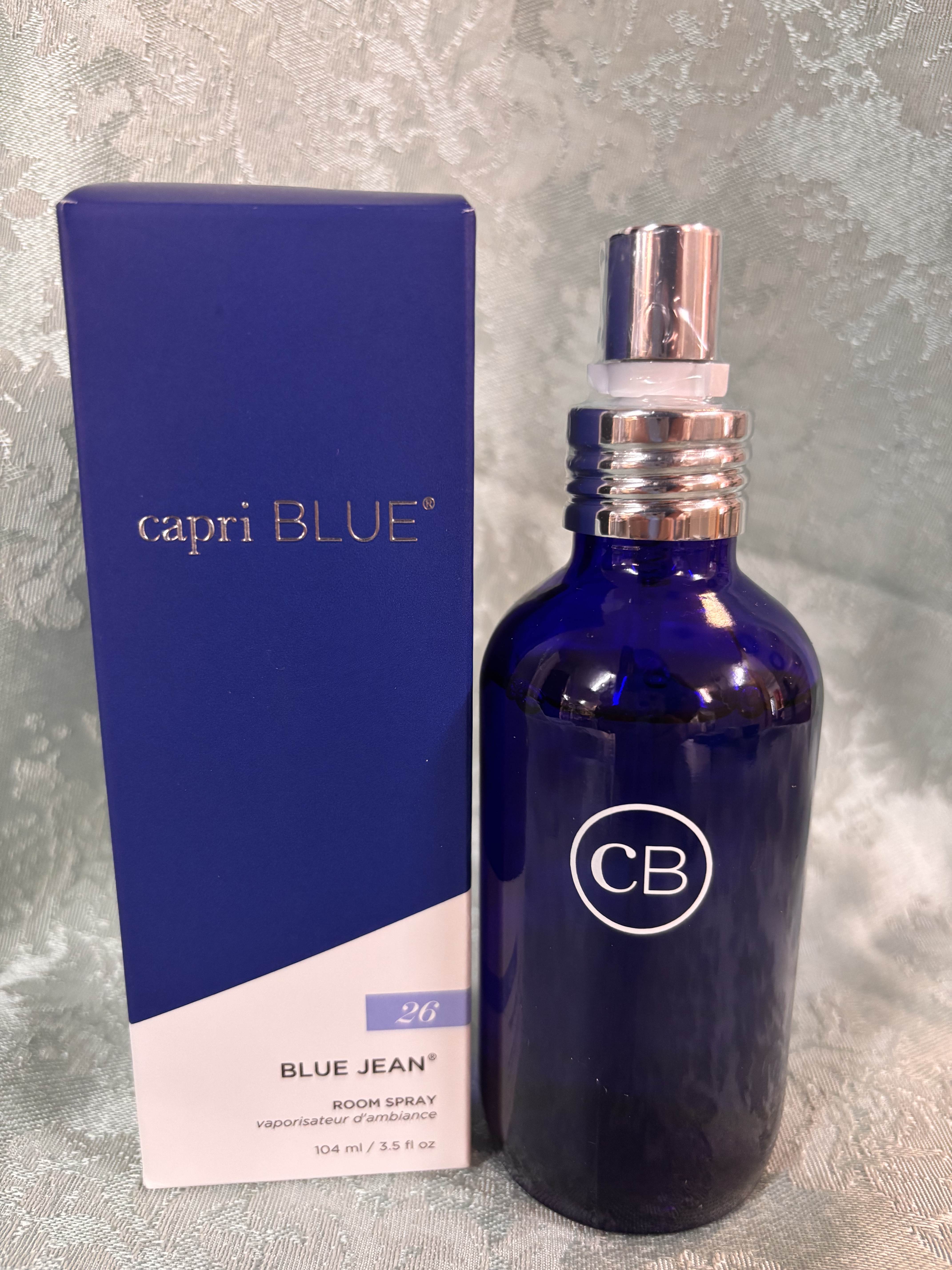 Blue room spray bottle beside its matching box