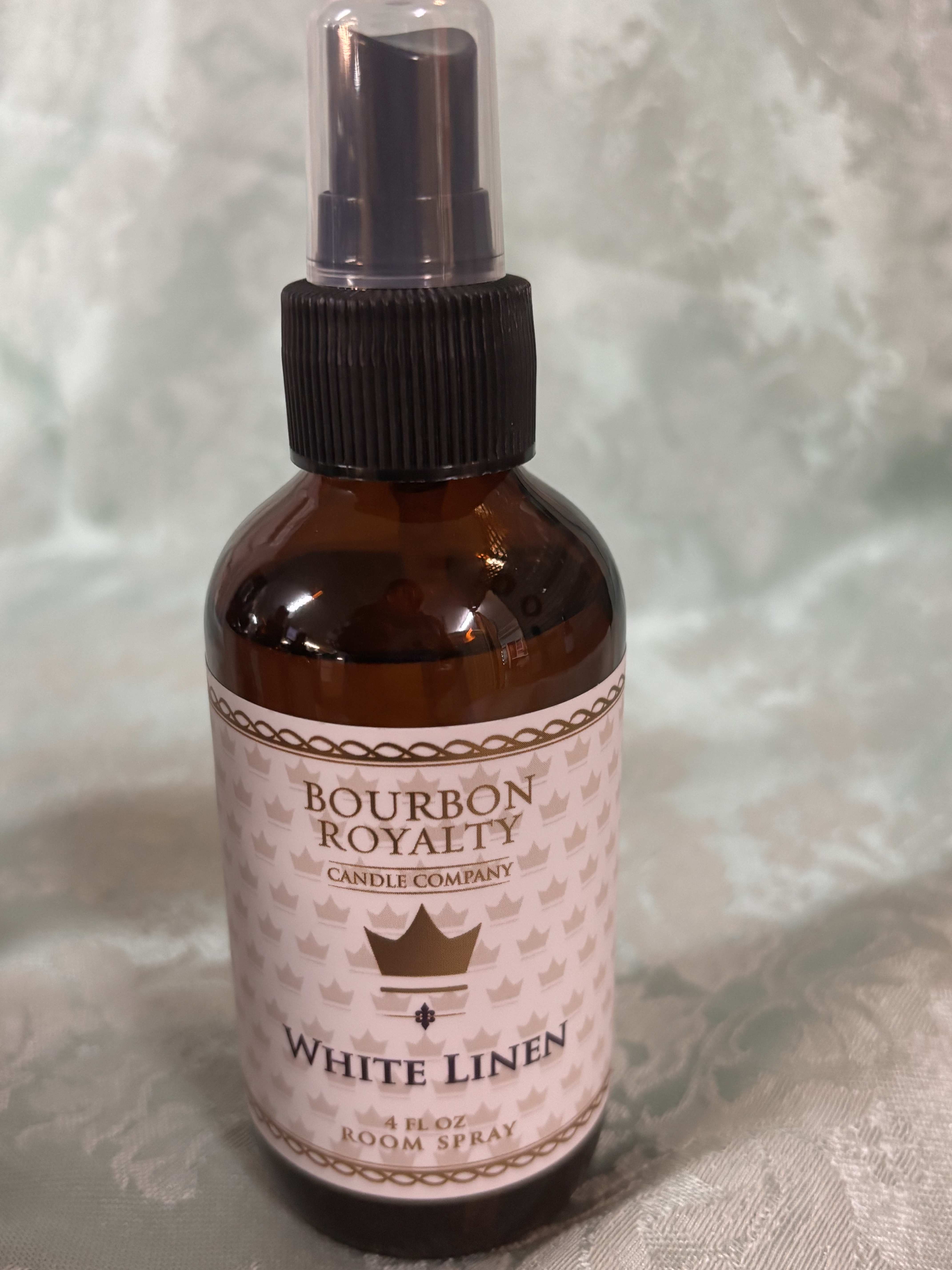 Amber bottle of White Linen room spray with a black pump top