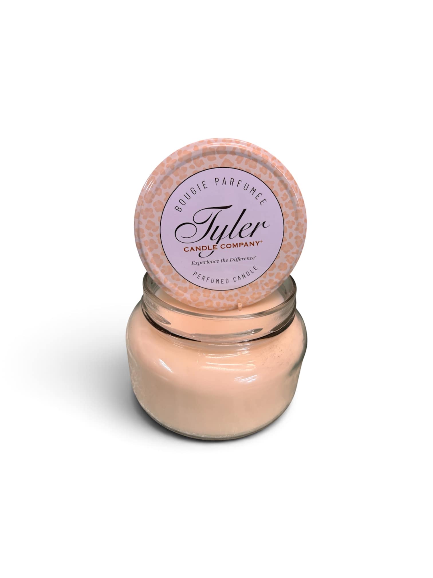 Peach scented candle in a glass jar with a round lid
