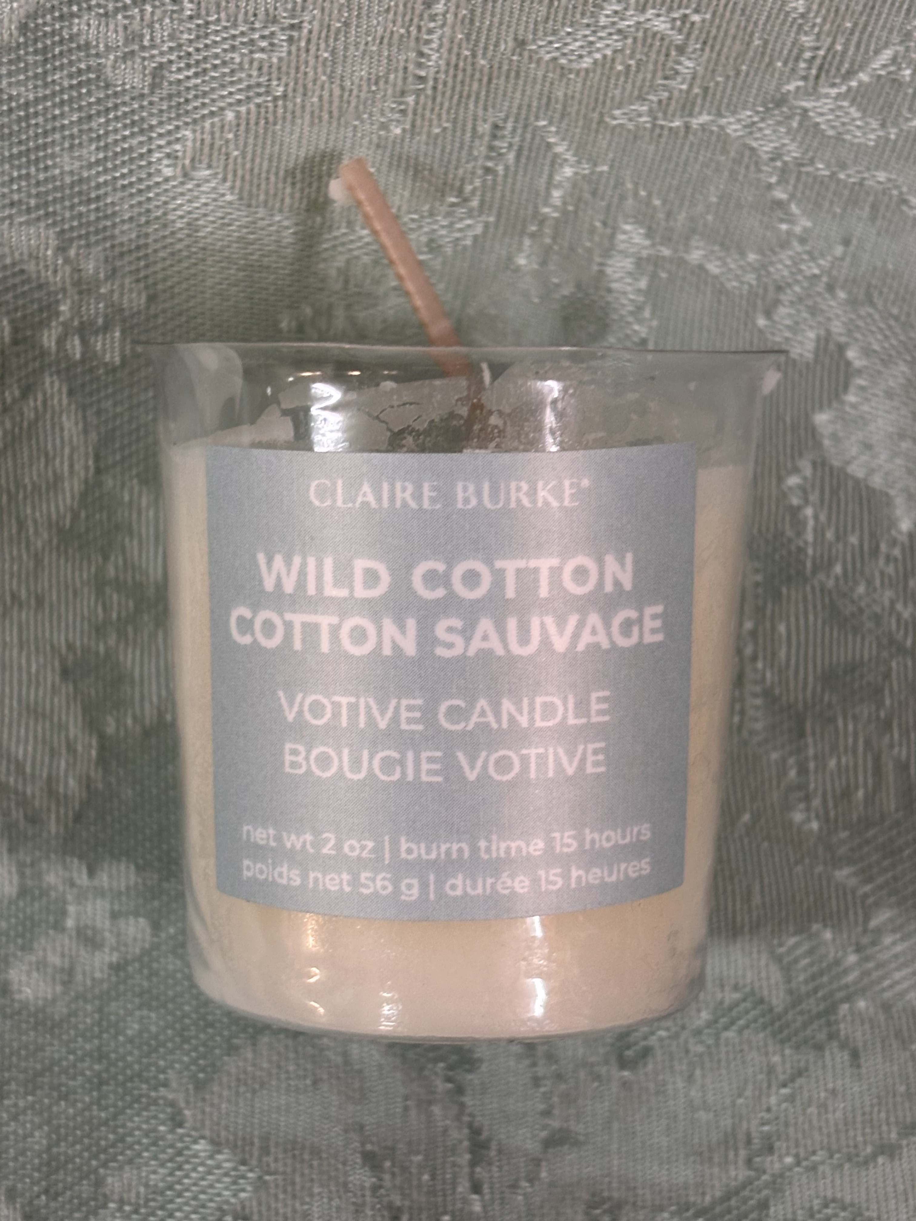 Glass votive candle labeled Wild Cotton Cotton Sauvage