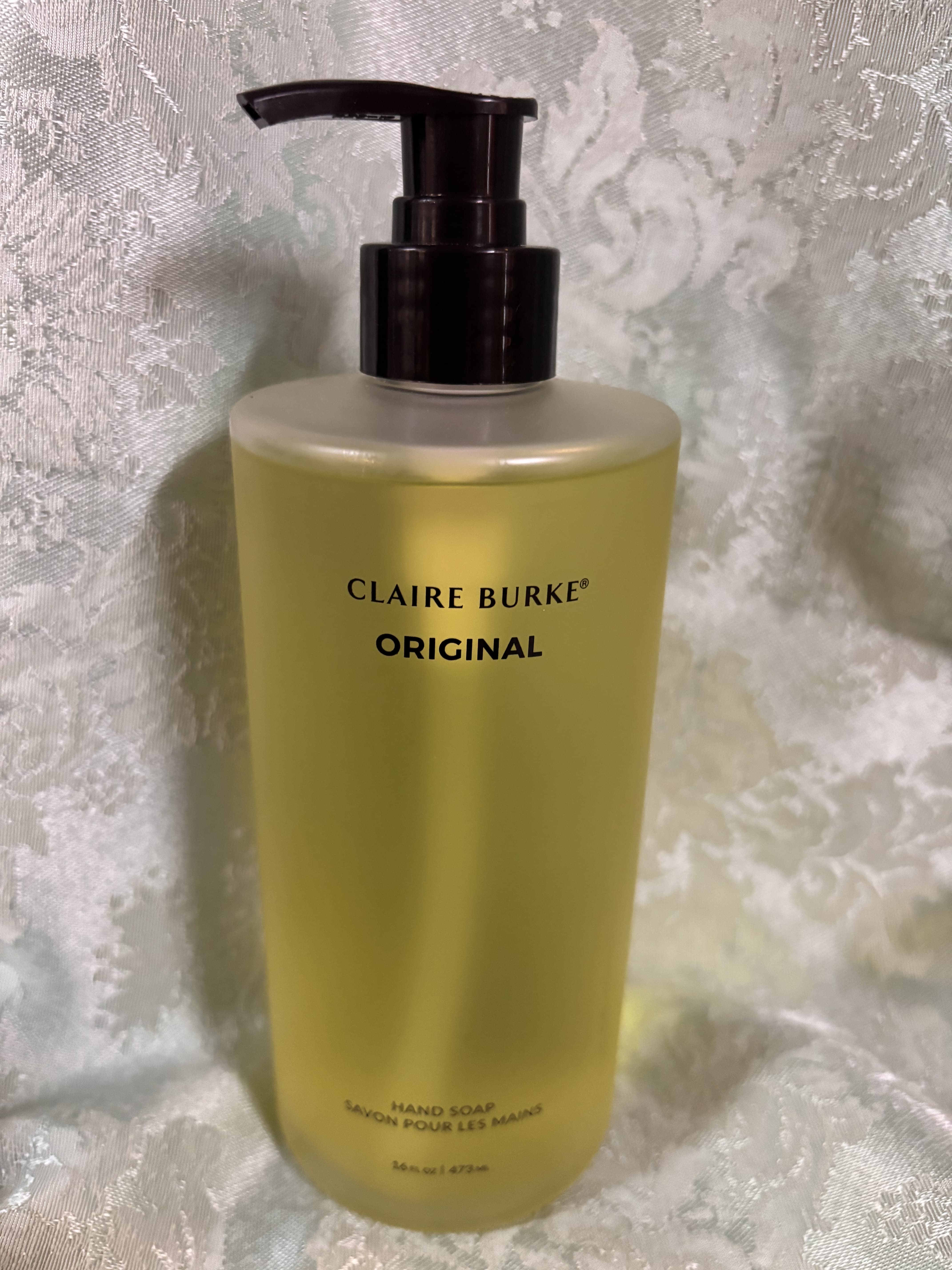 Yellow hand soap bottle with a black pump dispenser