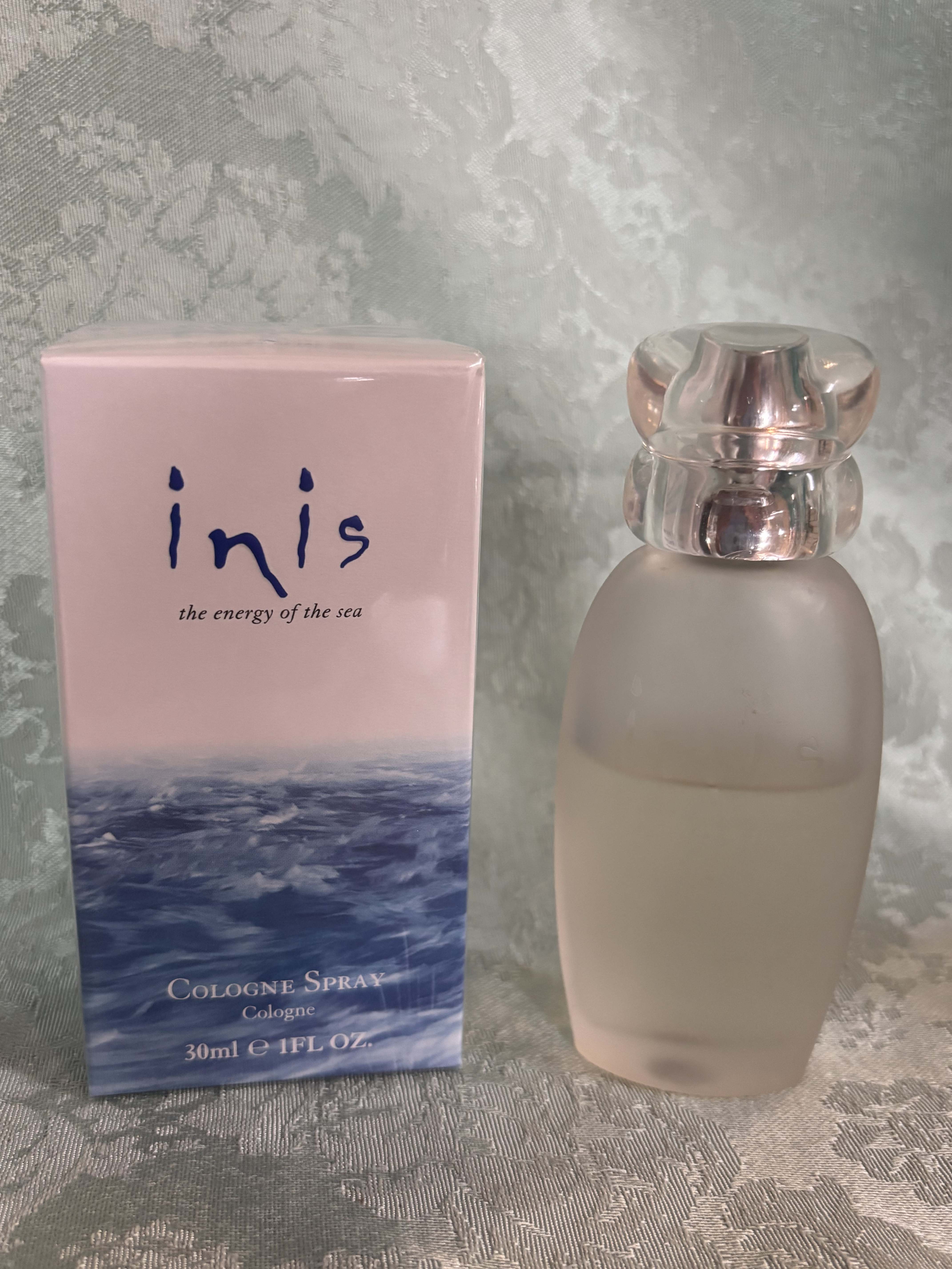 Pink cologne box beside a frosted glass perfume bottle