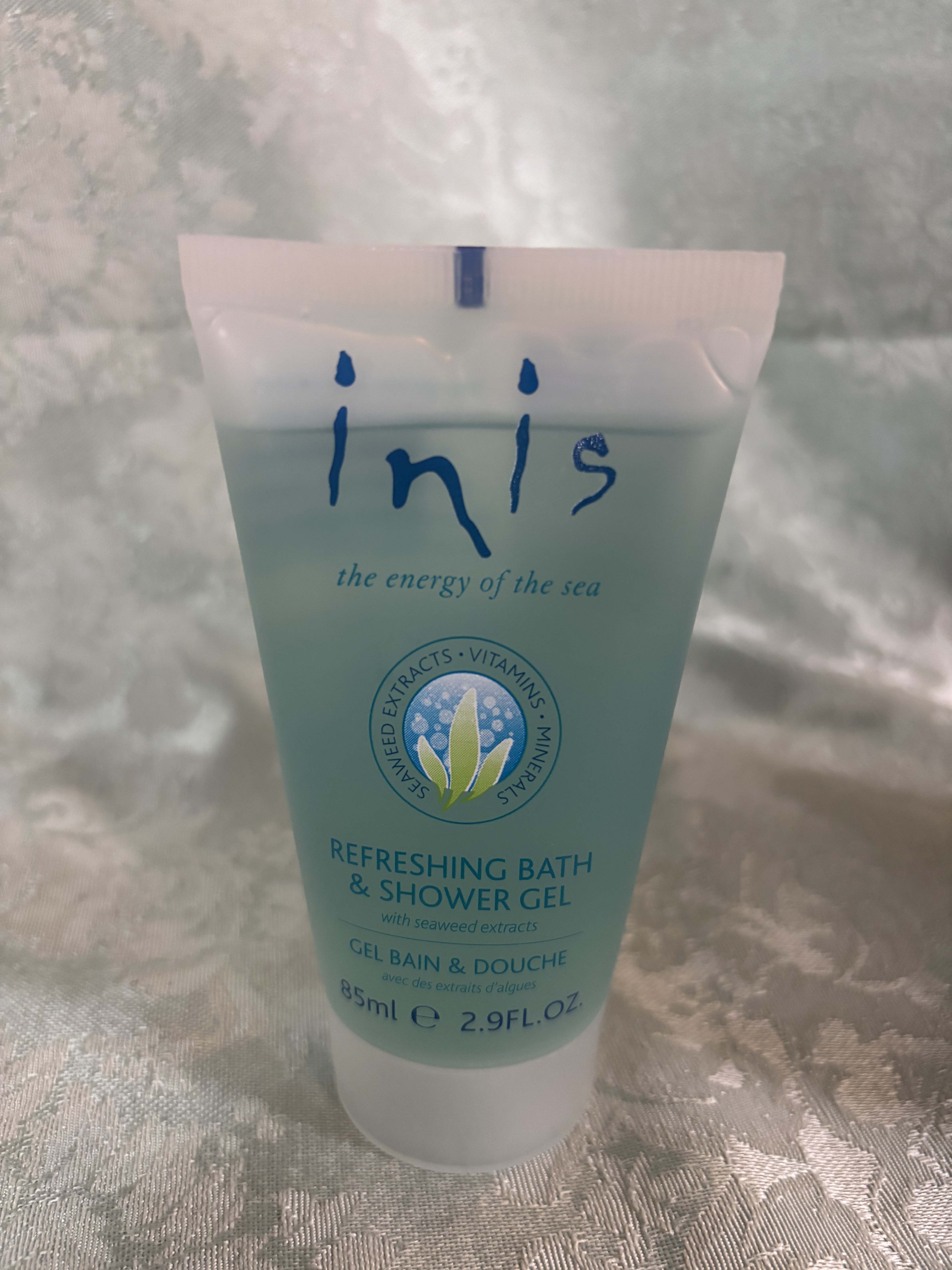 Tube of Inis refreshing bath and shower gel on a fabric surface