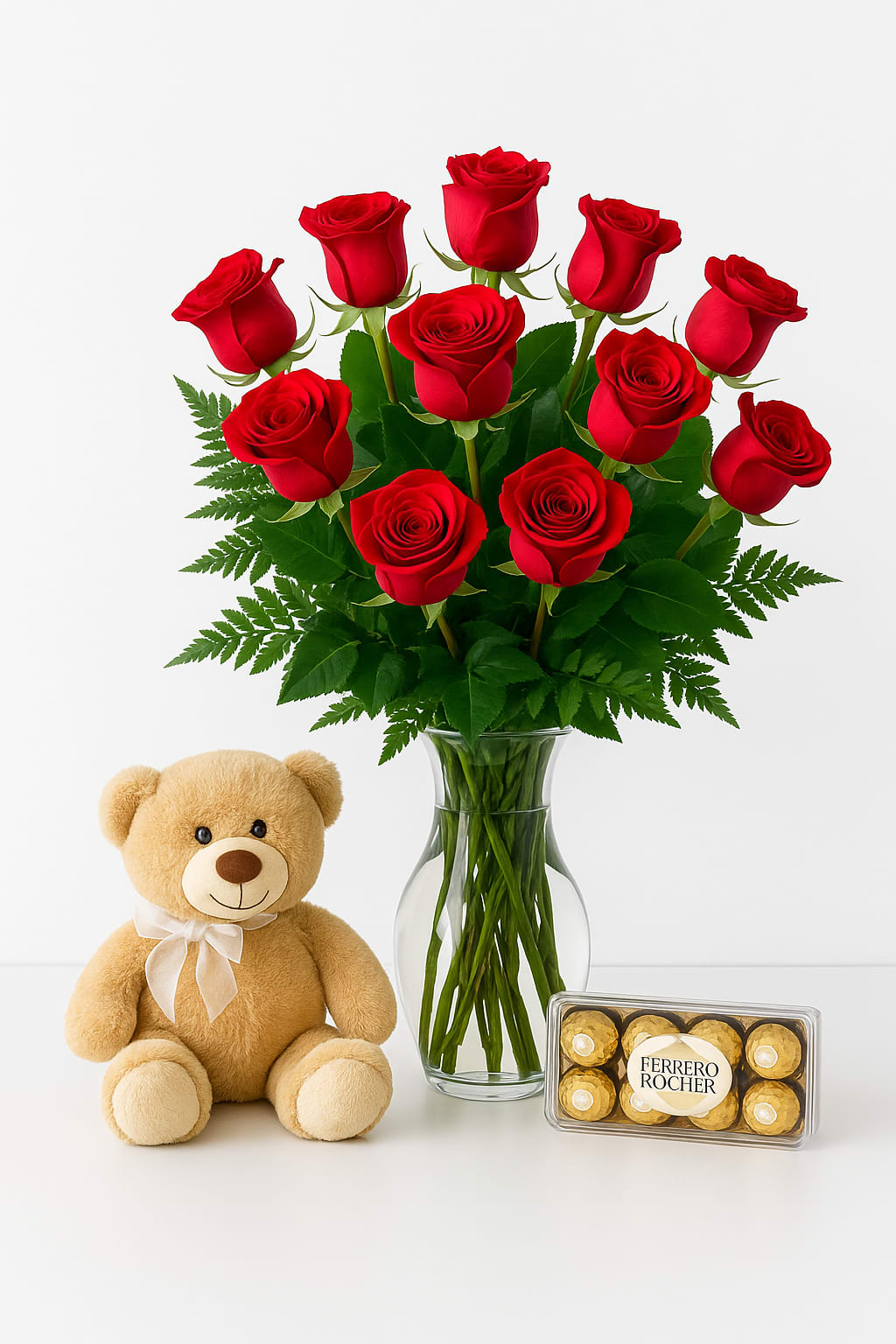 The Sweet Dozen – Roses, Bear &amp; Chocolates - A dozen radiant red roses arranged in a clear glass vase, paired with a box of delicious chocolates and a cuddly teddy bear. Don’t wait to surprise your special someone—perfect for birthdays, anniversaries, Valentine’s Day, or just because.