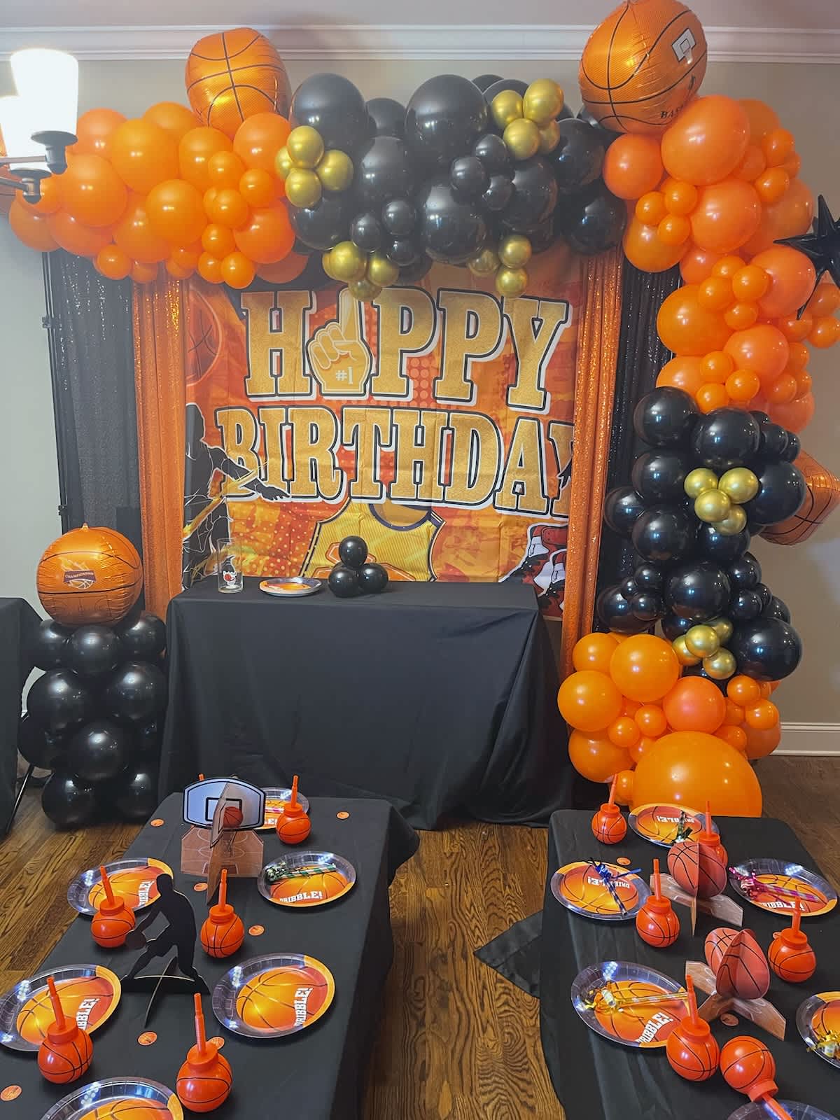 Basketball-themed birthday party setup with balloon arch and table decor
