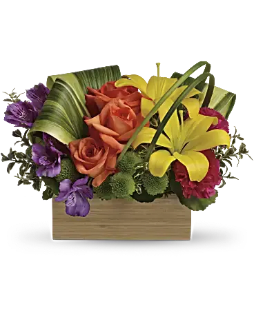 Colorful bouquet with roses and lilies in a wooden box