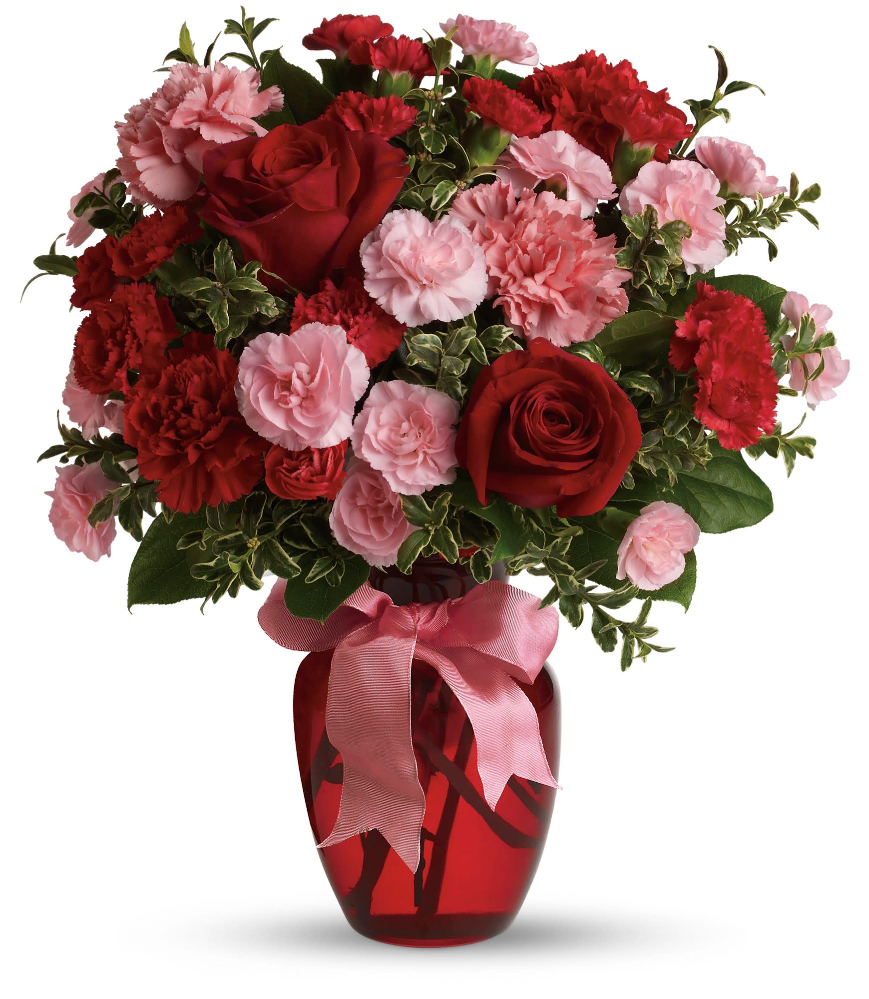 Red roses and pink carnations in a red glass vase with a pink ribbon