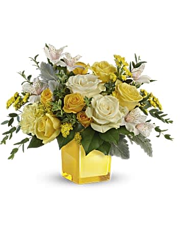 Yellow and white rose bouquet in a square glass vase
