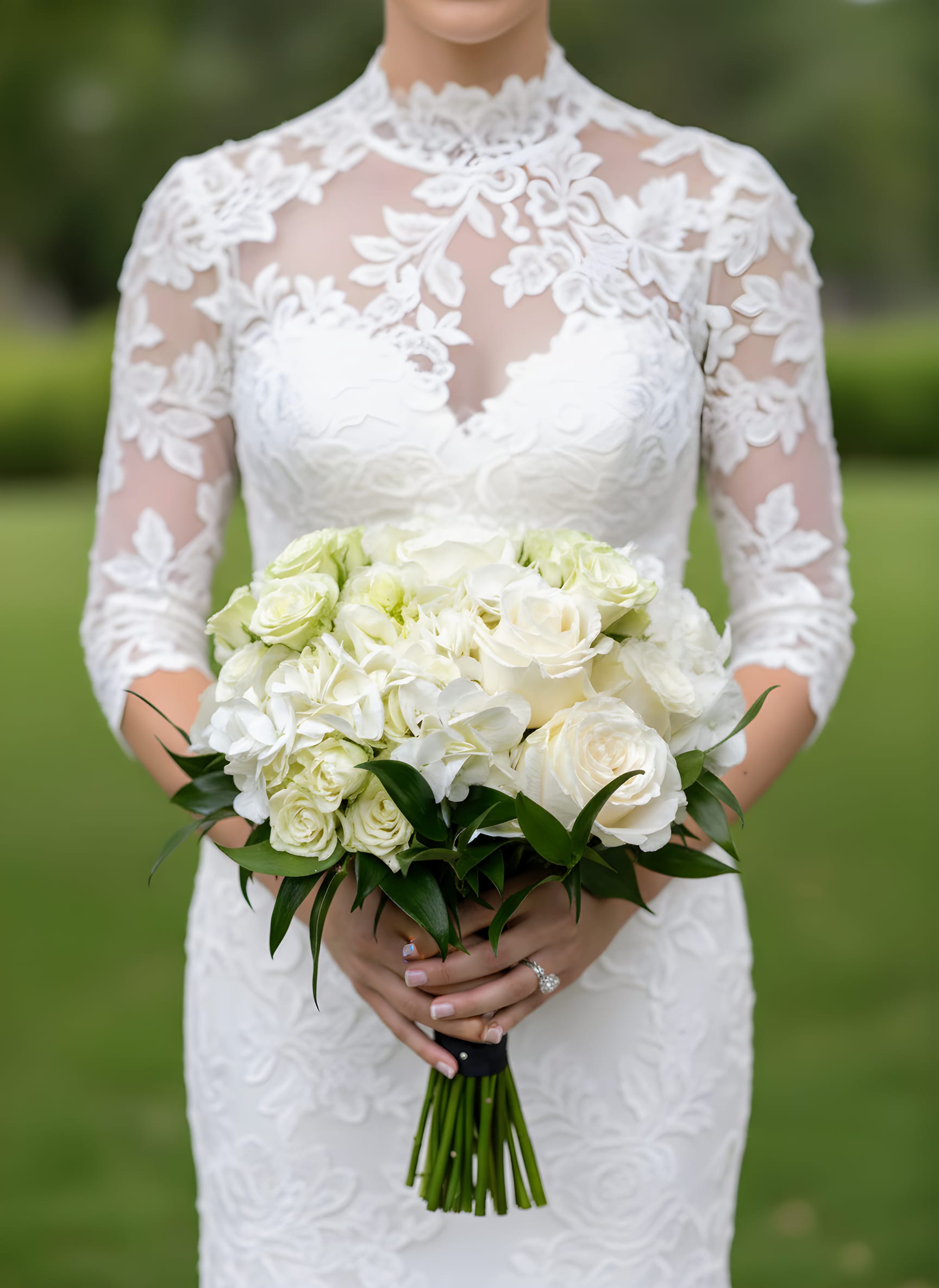Bride holding a white rose and hydrangea bouquet