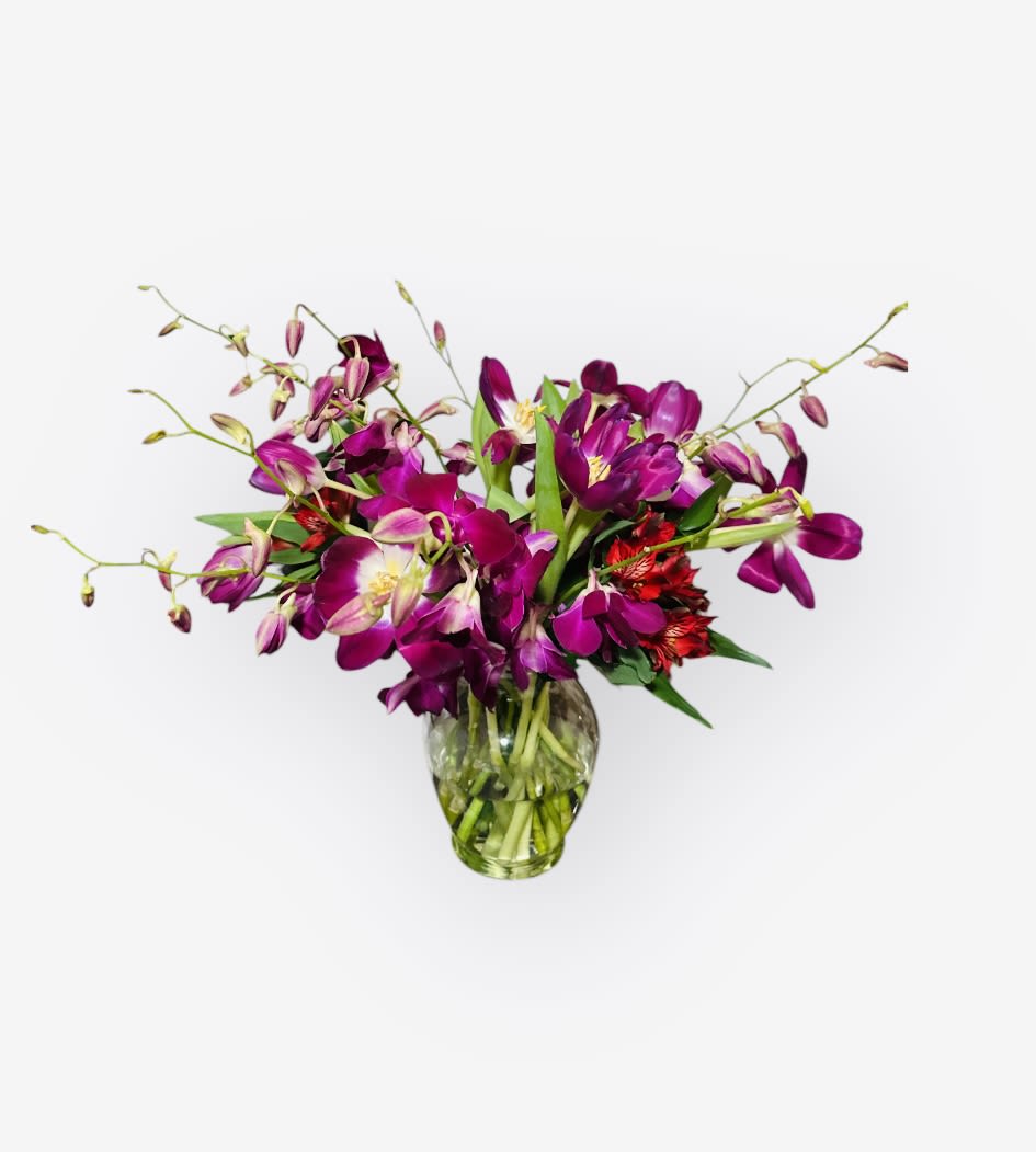 Purple orchid bouquet in a clear glass vase