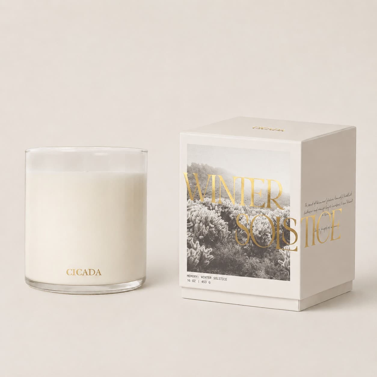 White candle in a clear glass jar beside a boxed candle set