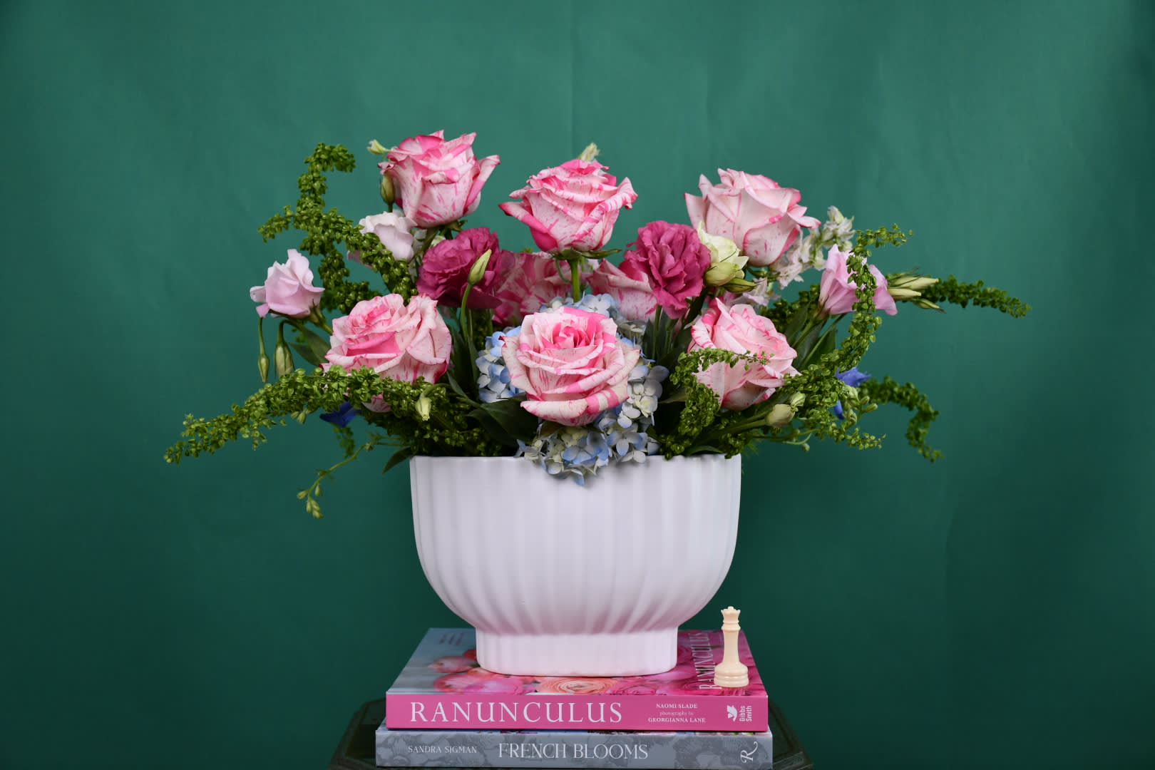 Pink roses and blue hydrangeas in a white vase