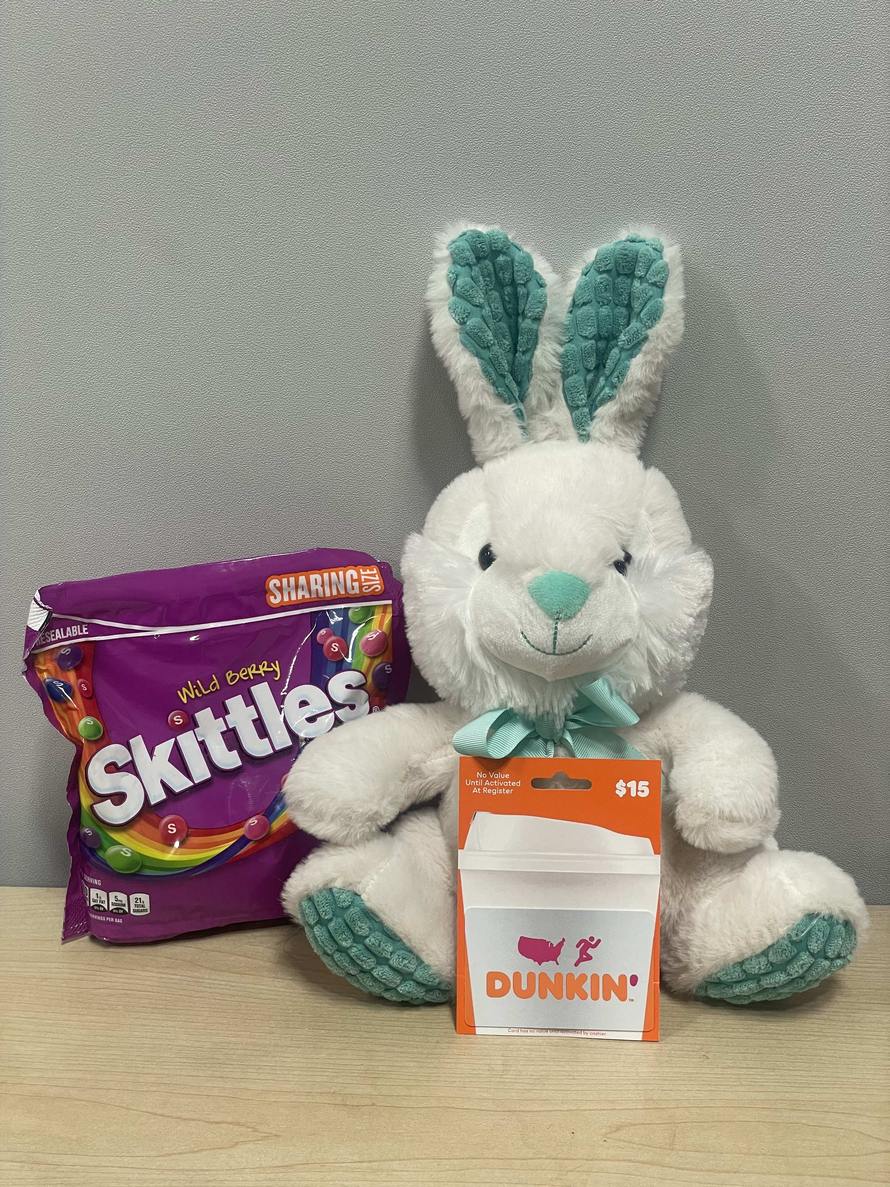 Plush bunny with a Skittles bag and Dunkin' gift card