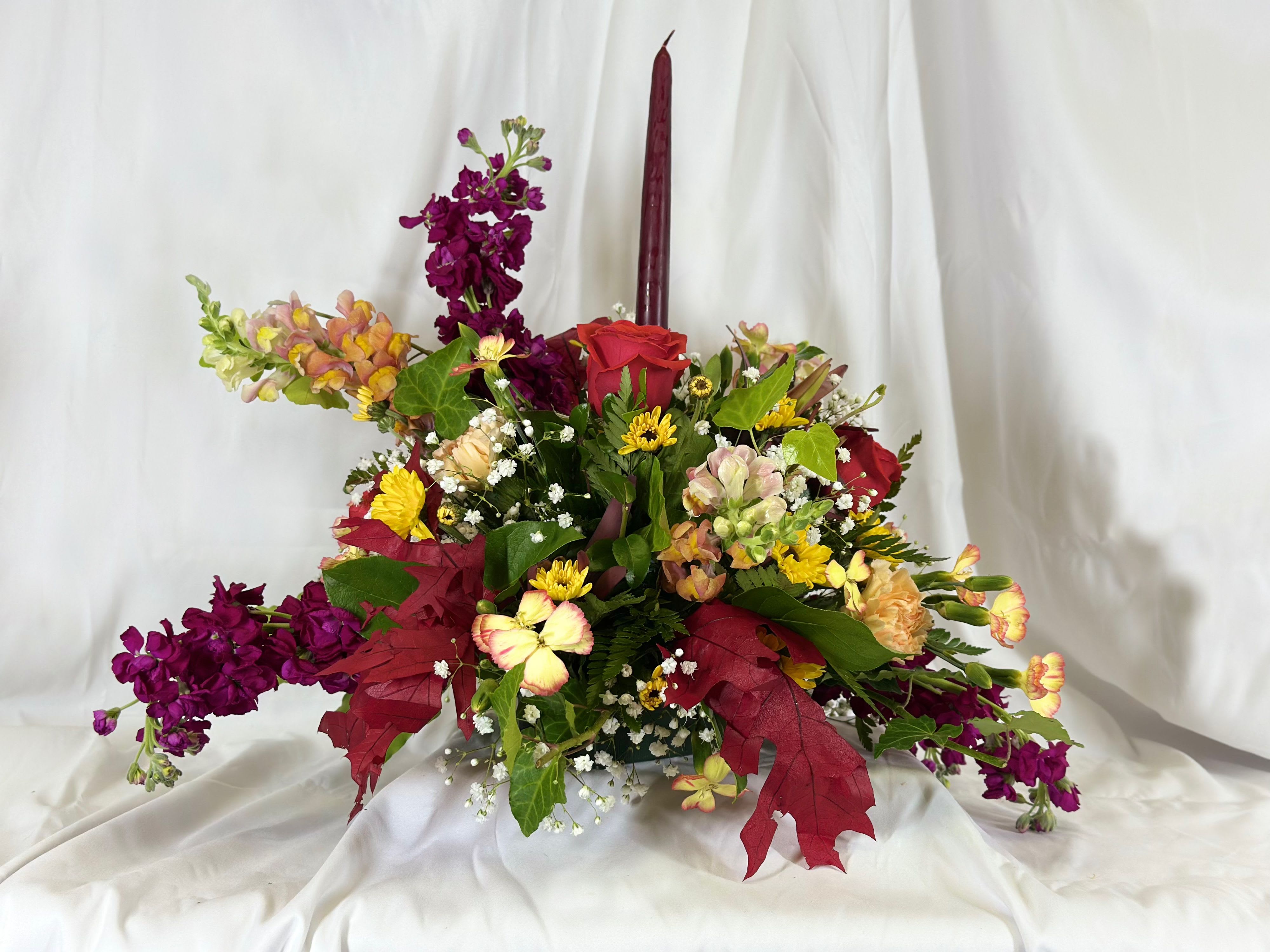 Thankful Table Centerpiece - This elegant centerpiece will be perfect for the Thanksgiving table, or any time throughout Autumn. It features roses, stock, and snapdragons in fall hues.