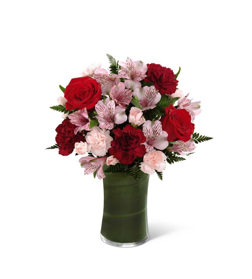 Love In Bloom Bouquet - Love in Bloom Bouquet is the perfect expression of sweet affection and adoration. Rich red roses, burgundy or red carnations, pink Peruvian lilies,and lush greens are gorgeously arranged in a clear glass vase lined with a ti leaf to create a stunning way to convey your most heartfelt emotions. GOOD bouquet includes 10 stems. BETTER bouquet includes 14 stems BEST bouquet includes 18 stems. 