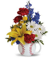 Mixed flowers arranged in a baseball-shaped mug