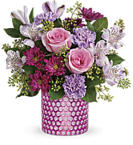 Pink and lavender mixed bouquet in a pink jeweled vase
