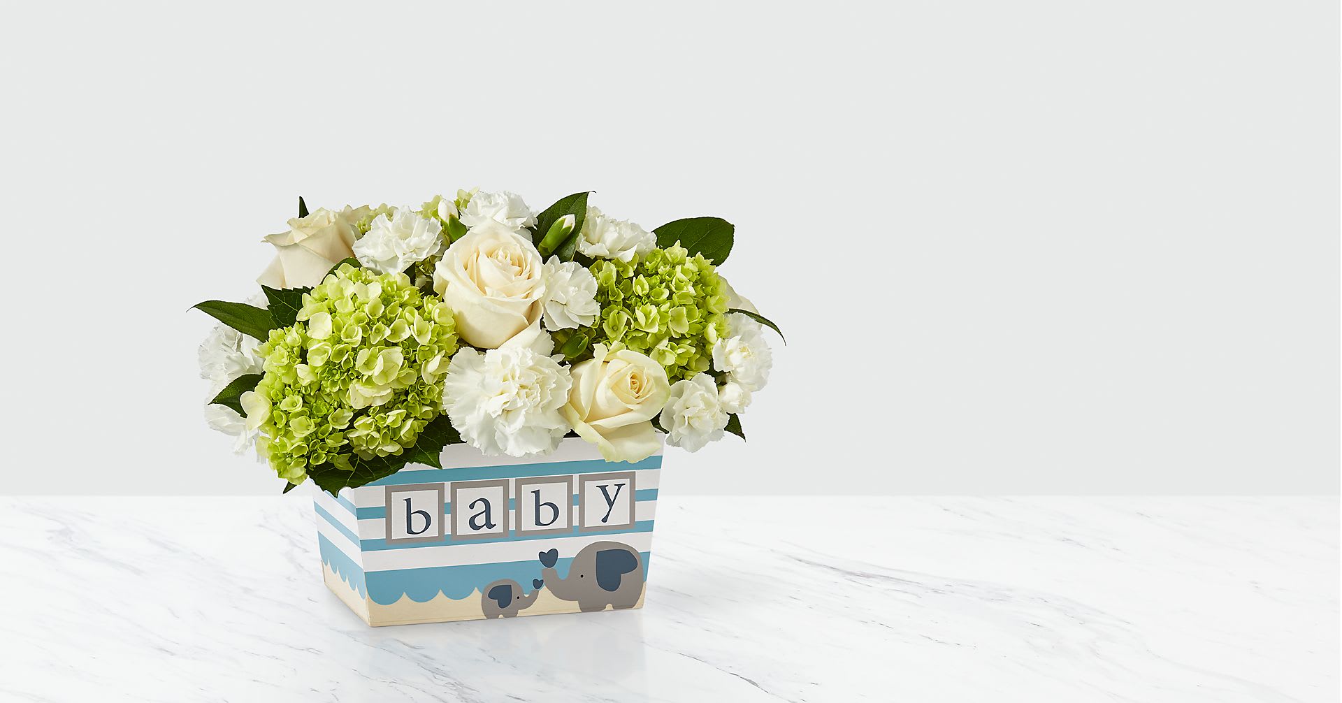 Cream roses and green hydrangeas in a baby-themed box