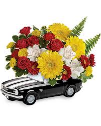 Flower arrangement in a black car-shaped container