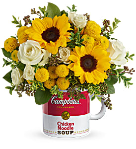 Sunflowers and white roses arranged in a Campbell's soup mug