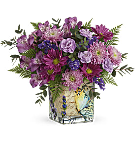 Purple mixed bouquet in a painted square vase