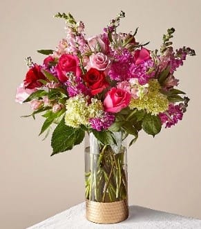 Bouquet of pink and red roses in a clear glass vase