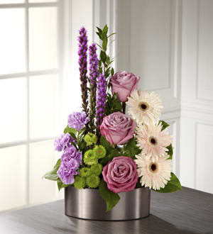 Pink roses and pale gerbera daisies in a silver vase
