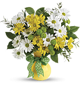 Yellow and white daisy bouquet in a yellow vase with a green polka-dot ribbon